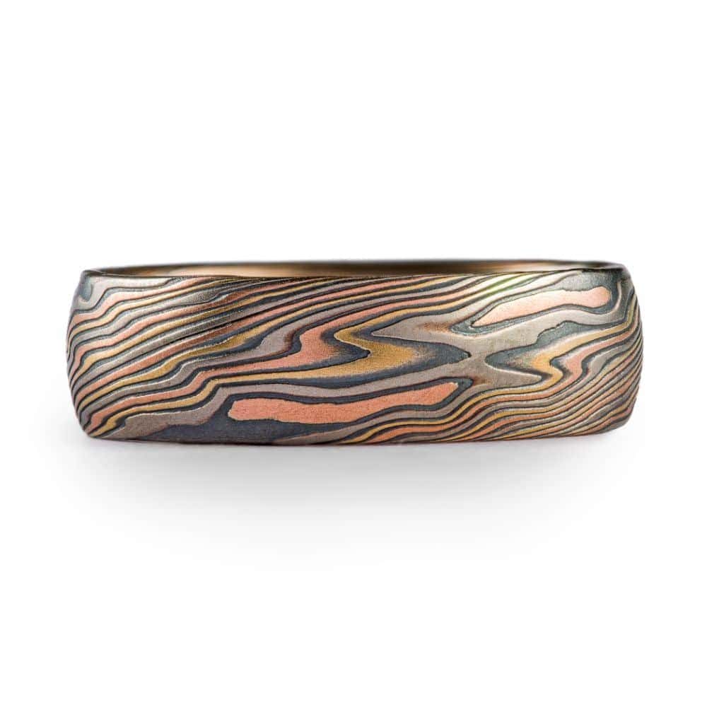high contrast mokume gane ring with oxidized silver, yellow gold, red gold and palladium for a mixed metal and organic look