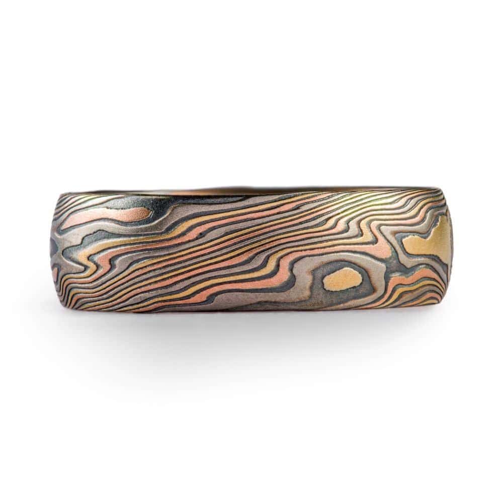 high contrast mokume gane ring with oxidized silver, yellow gold, red gold and palladium for a mixed metal and organic look