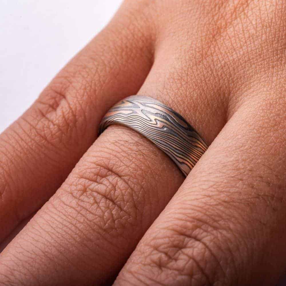 high contrast mokume gane ring with oxidized silver, yellow gold, red gold and palladium for a mixed metal and organic look