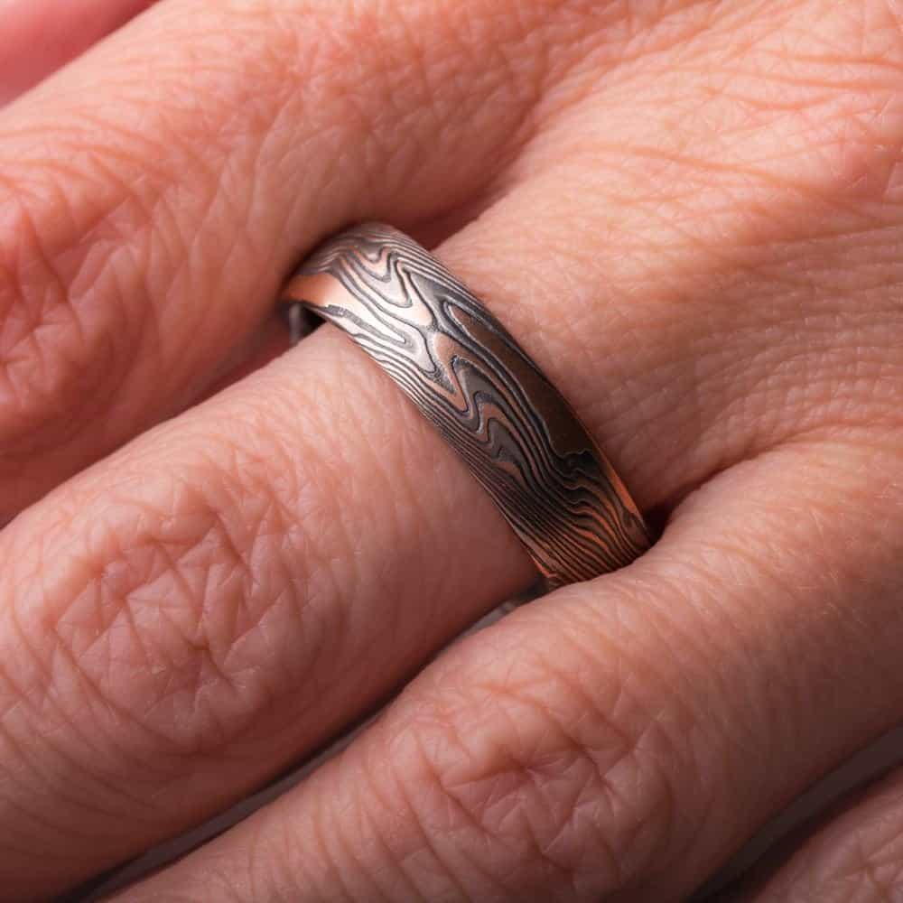 mokume twist patterned ring with dark look, made with red gold, palladium and oxidized silver