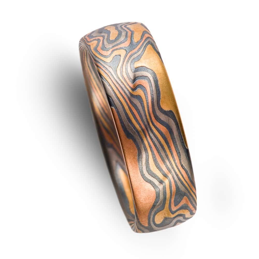wide mokume gane patterned band, made with multiple different metals in a twist pattern