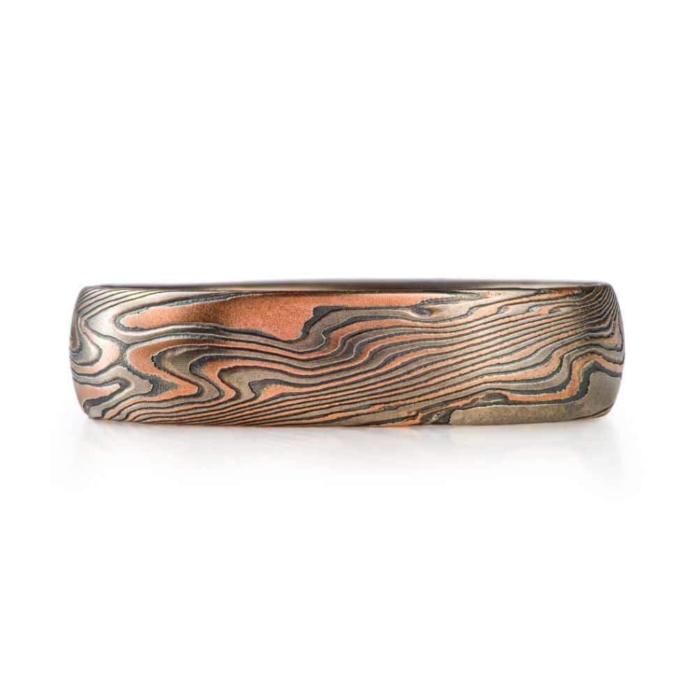 dark looking mokume gane twist patterned ring, made with red gold, palladium and oxidized silver