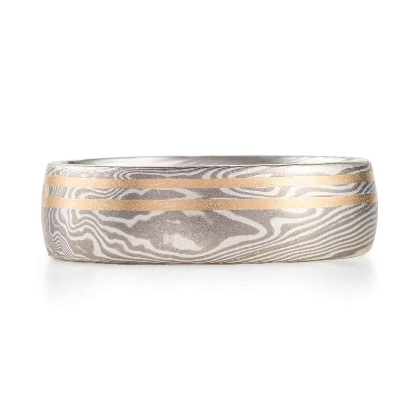 mokume gane silvery ring with two yellow gold lines running perfectly parallel around the band