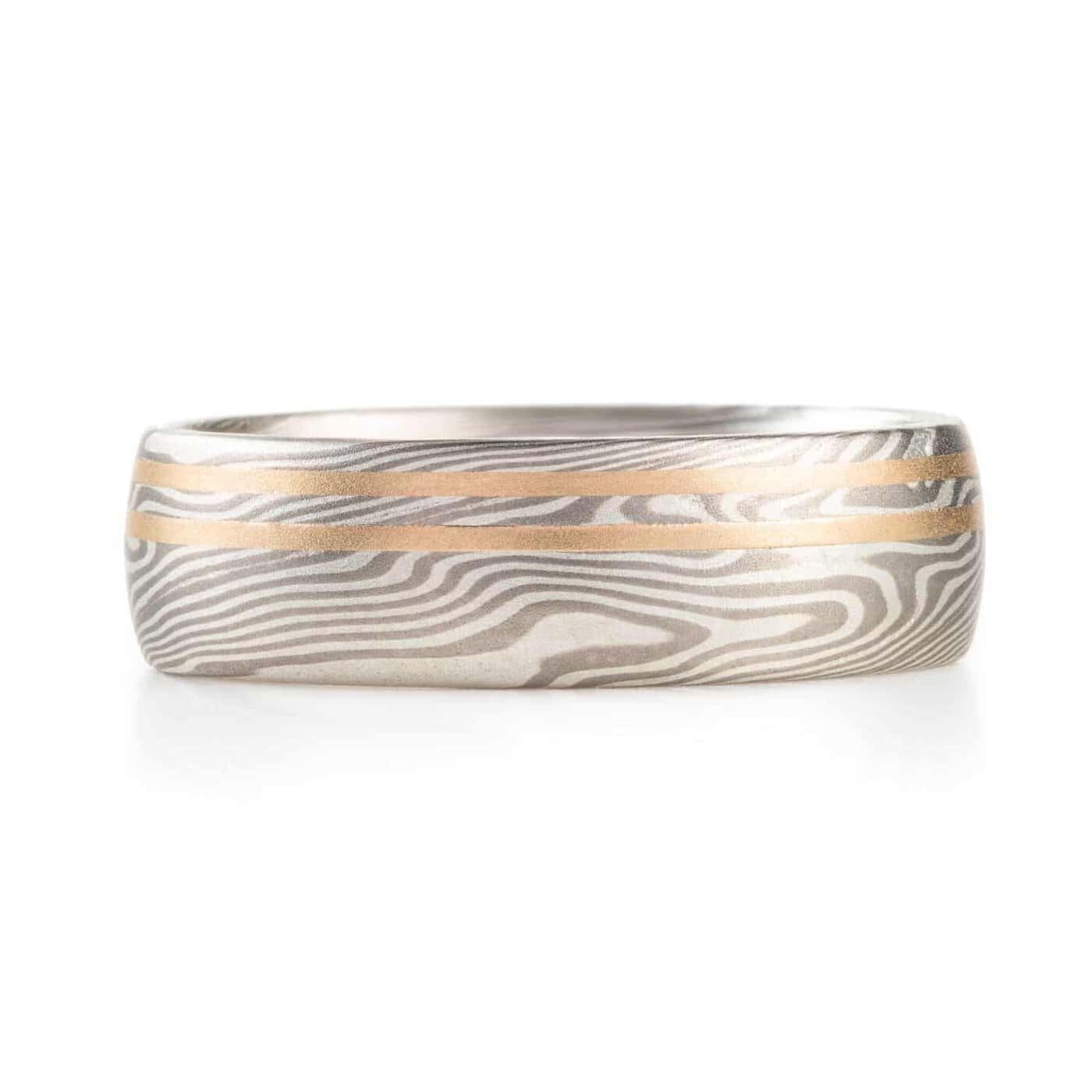 mokume gane silvery ring with two yellow gold lines running perfectly parallel around the band