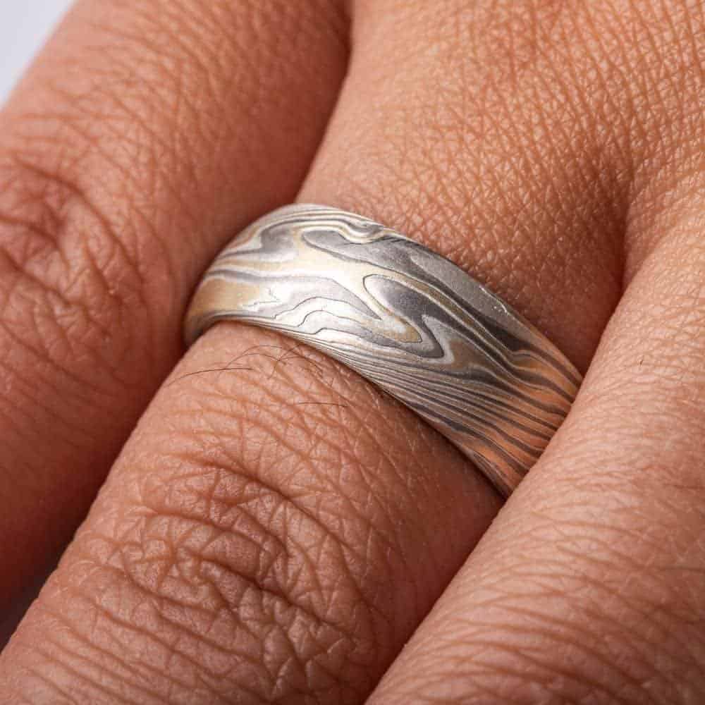 wide twisted pattern ring with textured finish, made with yellow gold, palladium and silver