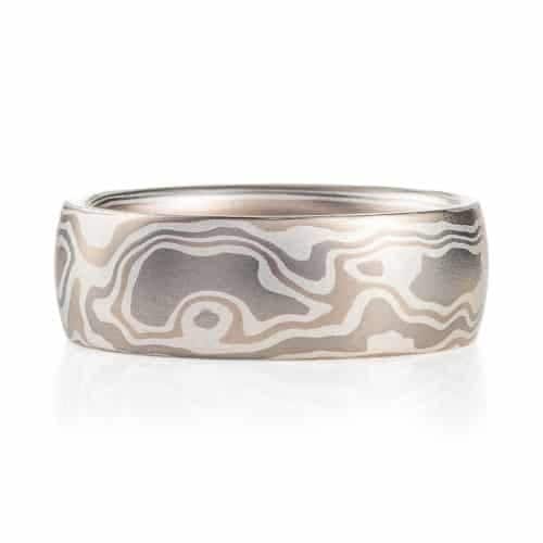 mokume gane ring made with light silvery metals in a pattern resembling woodgrain.