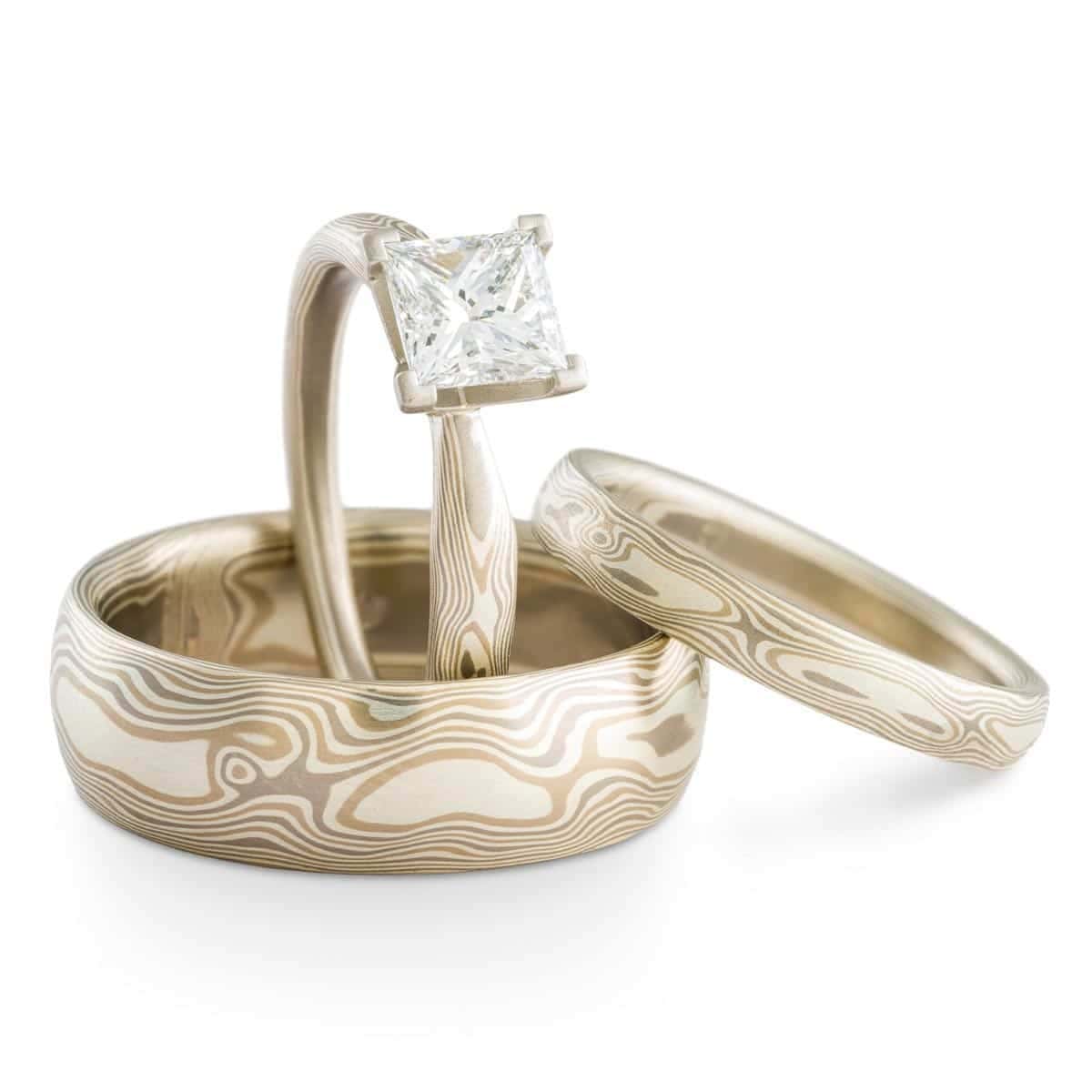 three-ring Mokume Gane set made in our Woodgrain pattern and Smoke palette. The Smoke metal combination features 14k white gold, palladium, and sterling silver.
