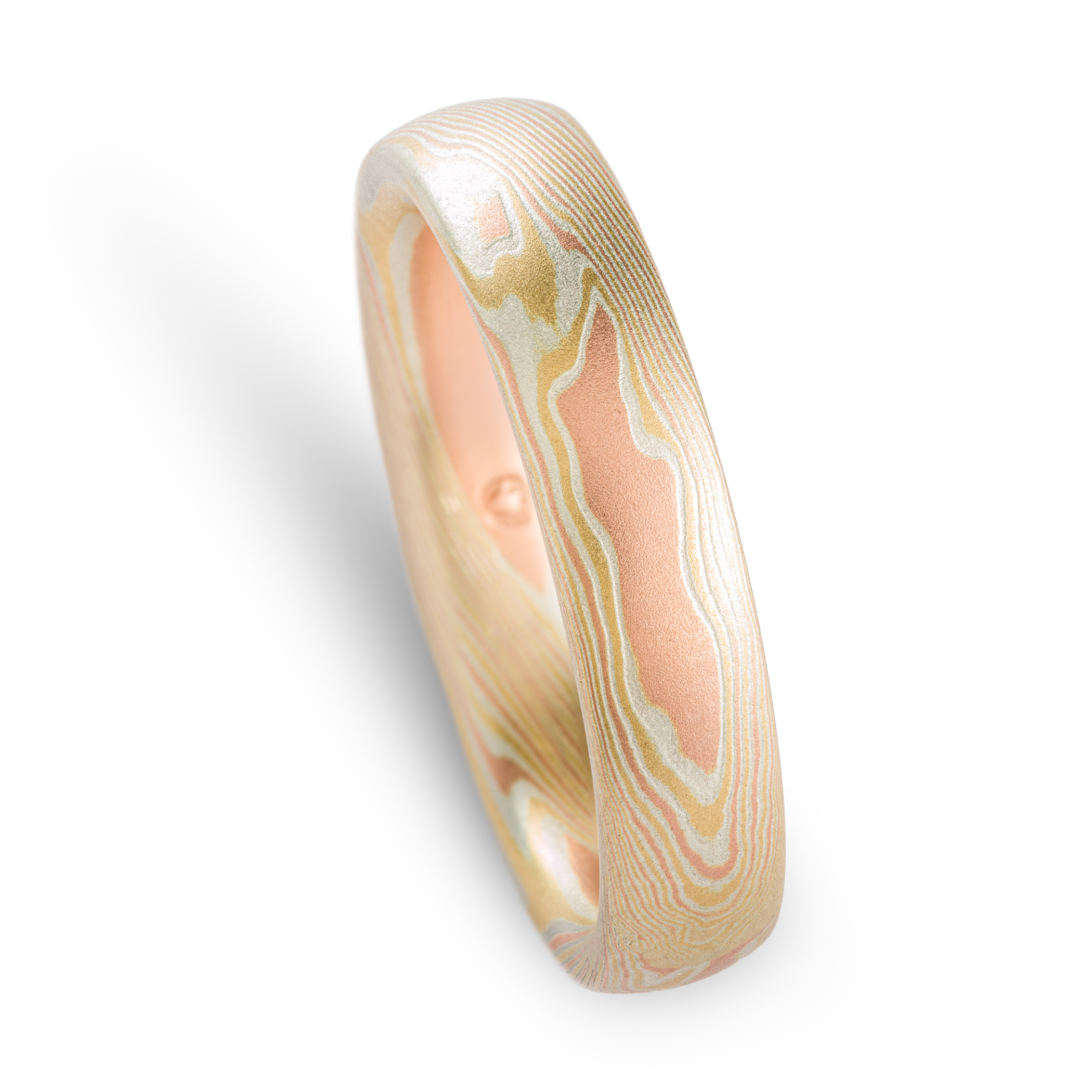Yellow and red gold mokume gane patterned ring, made in an organic twisting pattern that resembles wood grain.