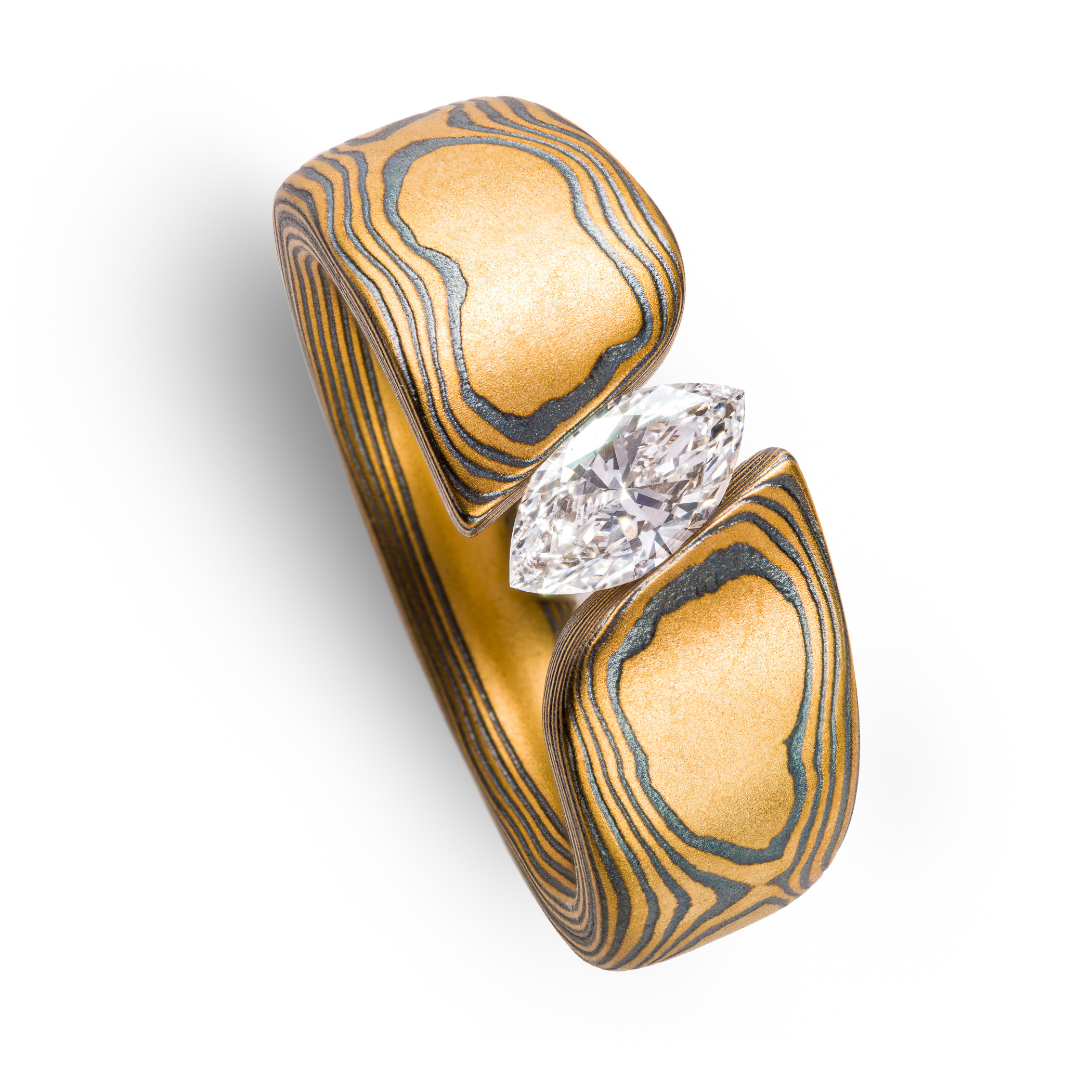 large and bold mokume gane tension set ring, featuring a beautiful marquise cut diamond set at an angle