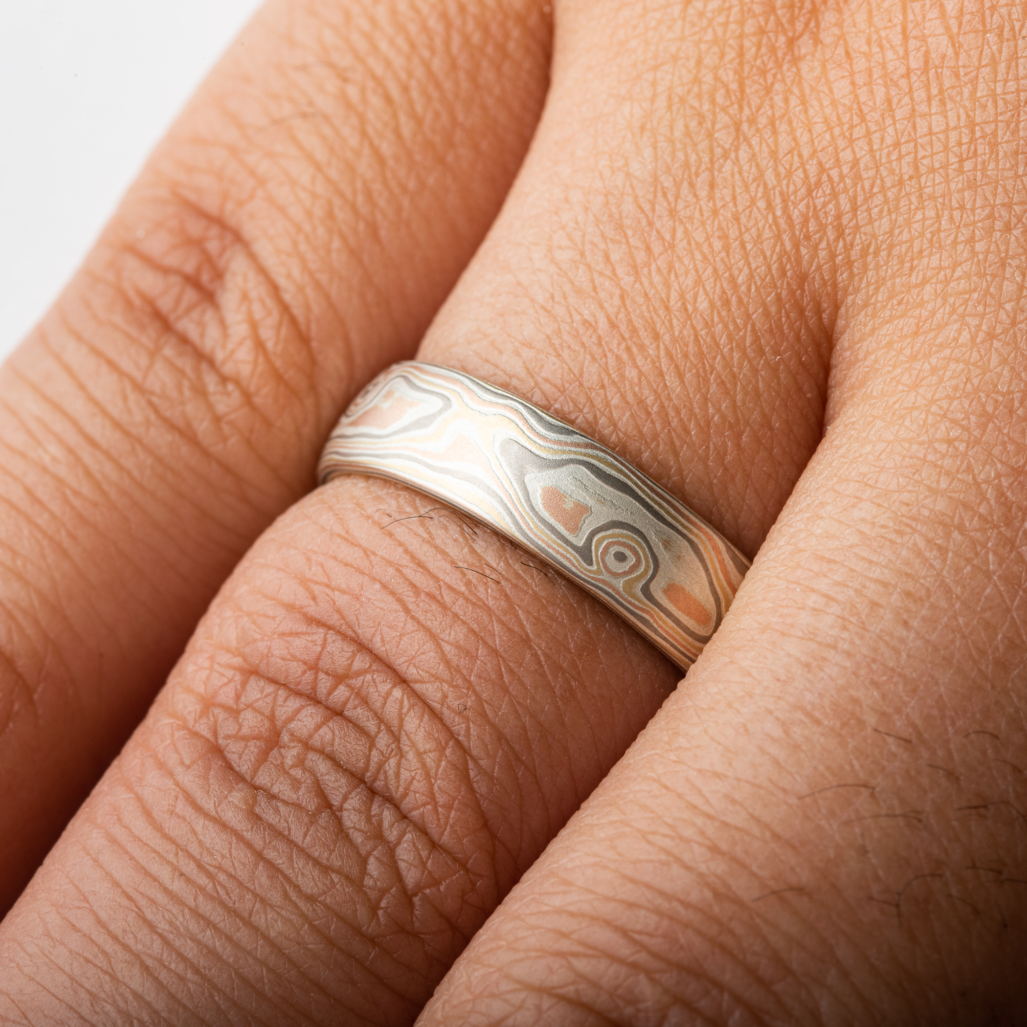 mens wedding ring in red gold yellow gold and palladium. mokume gane custom made