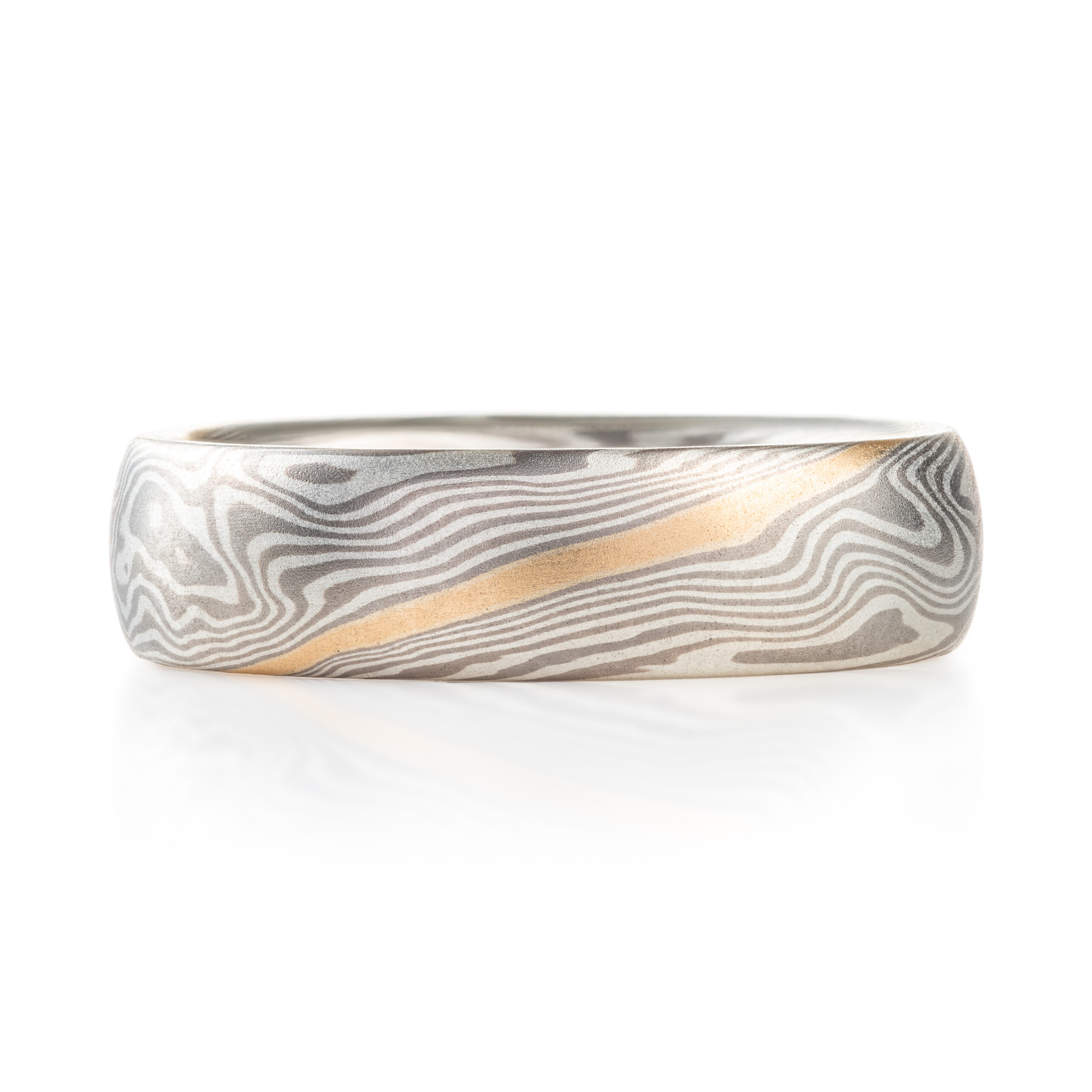 mokume gane band with a flush set diamond and an added yellow gold stratum layer