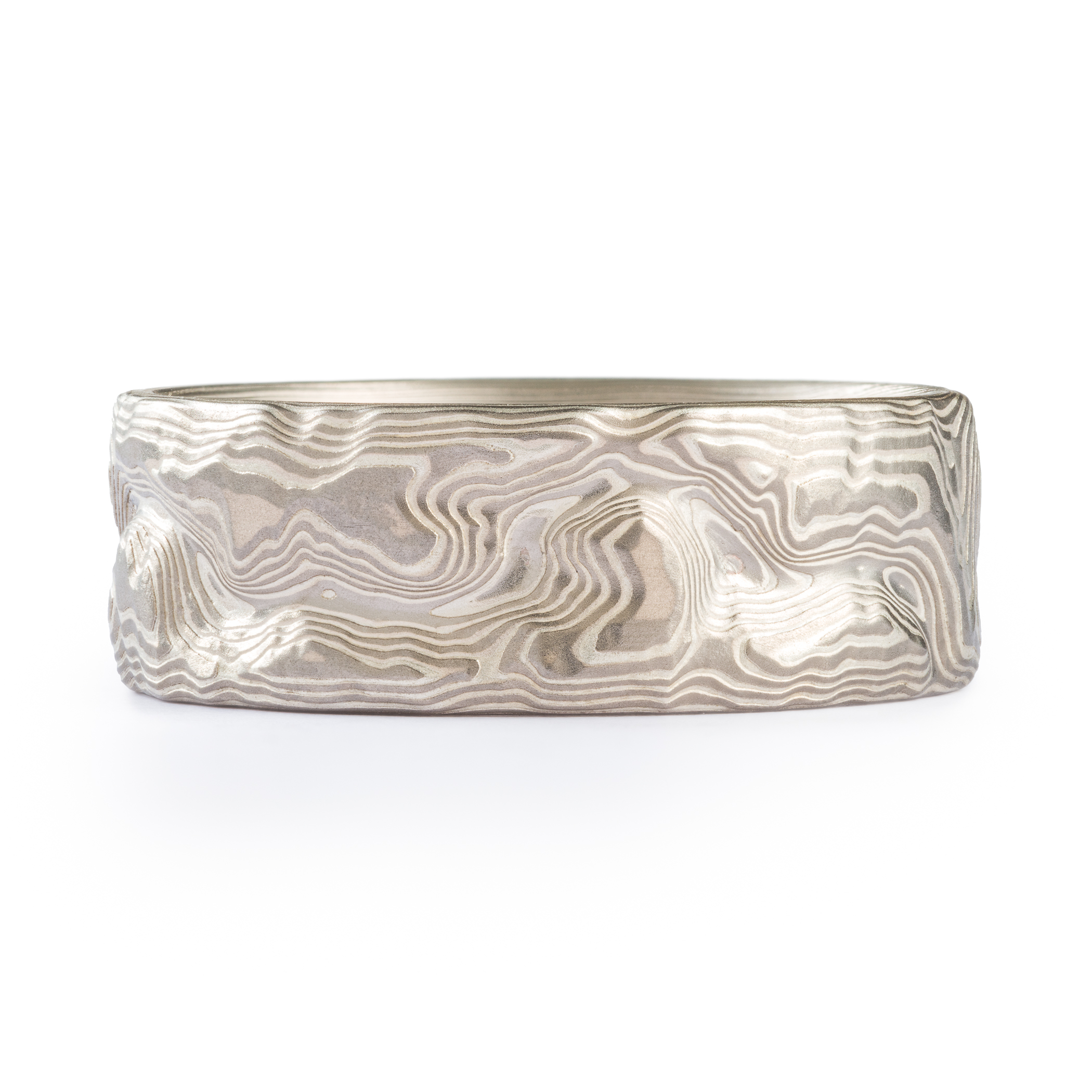 Custom carved mokume gane ring where the pattern resembles the topographic map of a specific place. Made with palladium and etched silver.