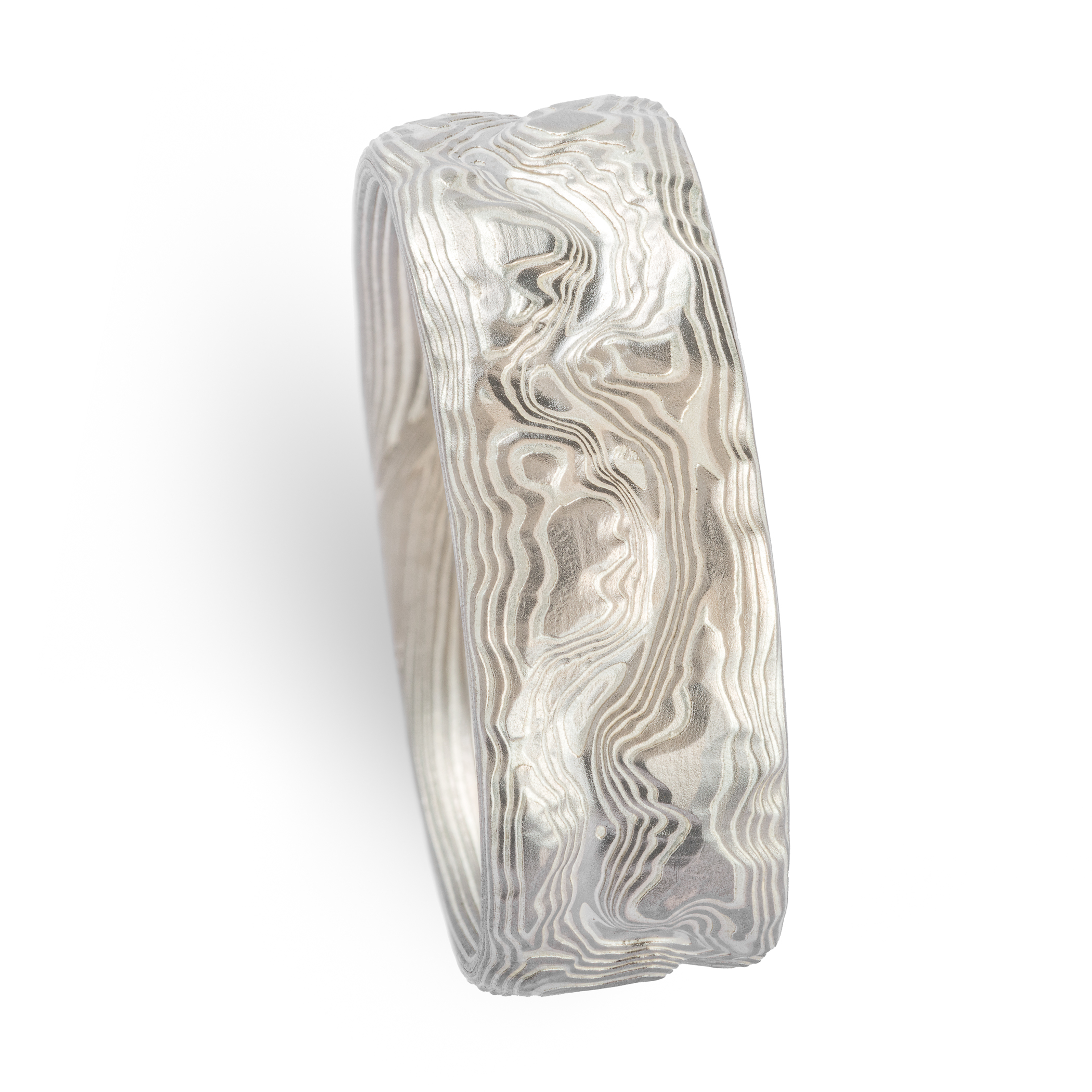 Custom carved mokume gane ring where the pattern resembles the topographic map of a specific place. Made with palladium and etched silver.