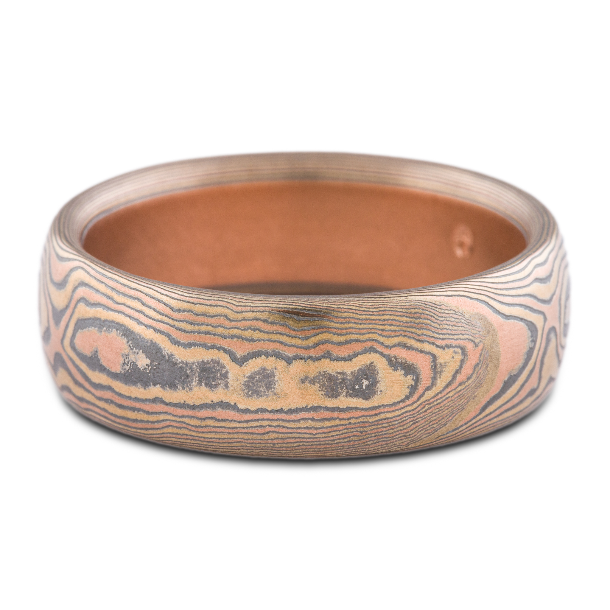 warm toned mokume gane band patterned to look like woodgrain