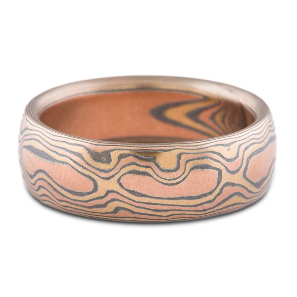 warm toned mokume gane band patterned to look like woodgrain