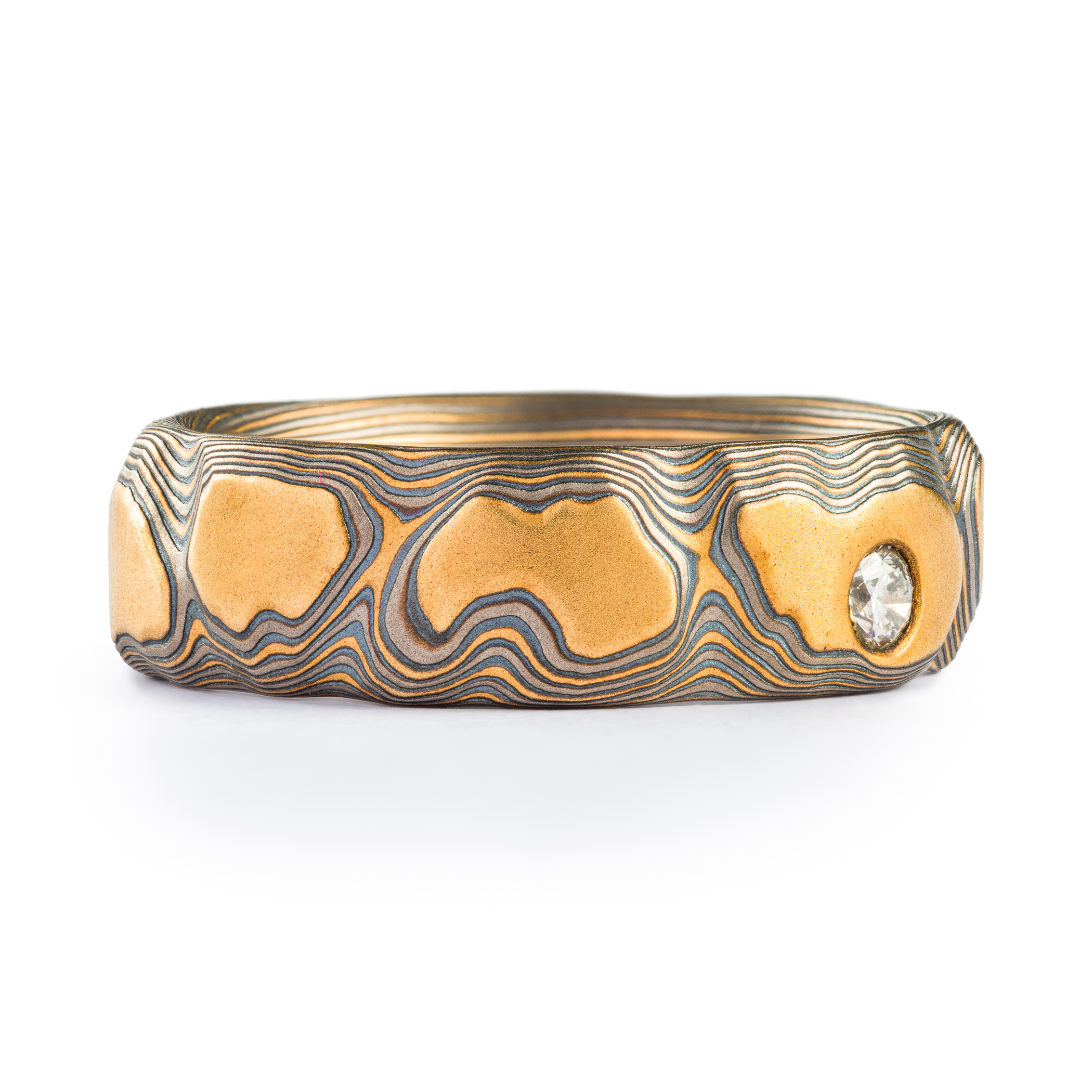 yellow gold, silver and palladium metal with striped Guri Bori, mokume gang with a raw diamond inset in the yellow gold
