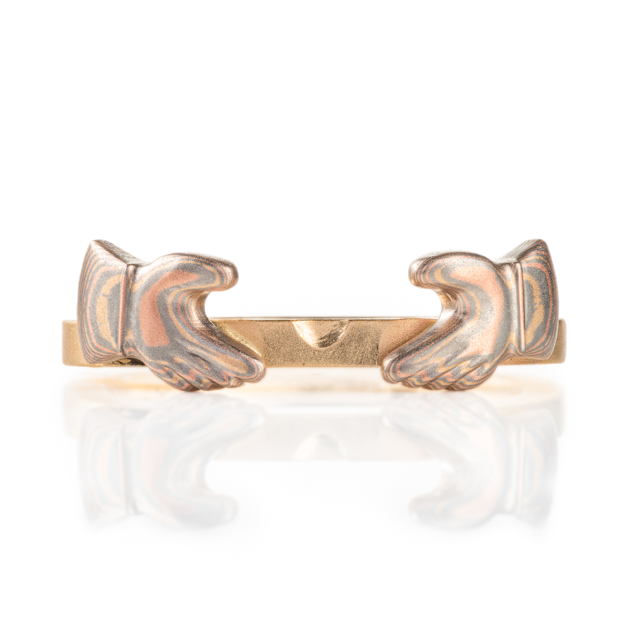 custom made three part claddagh ring, with mokume hands holding a white sapphire heart shaped stone, with a mokume crown on top of the stone