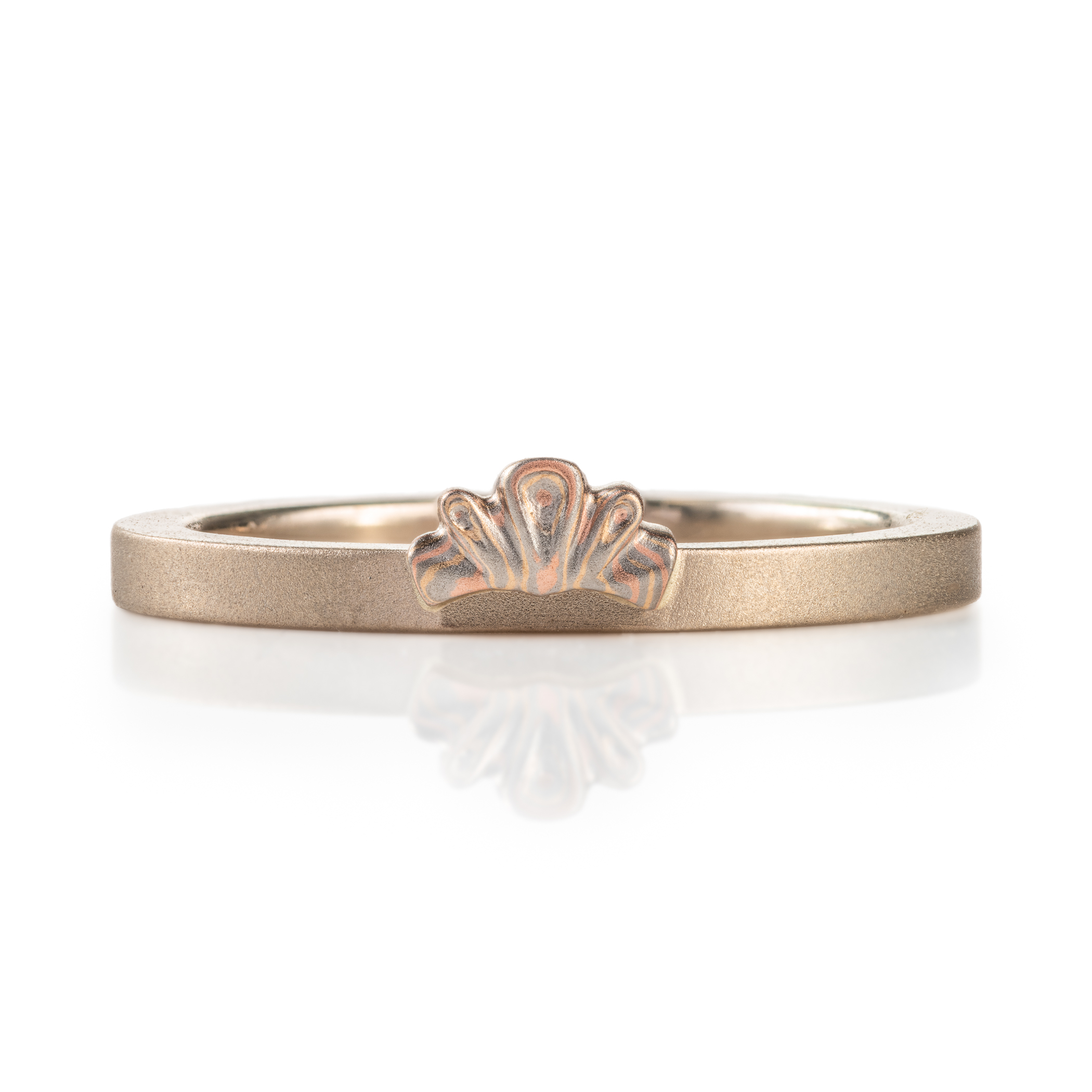 custom made three part claddagh ring, with mokume hands holding a white sapphire heart shaped stone, with a mokume crown on top of the stone