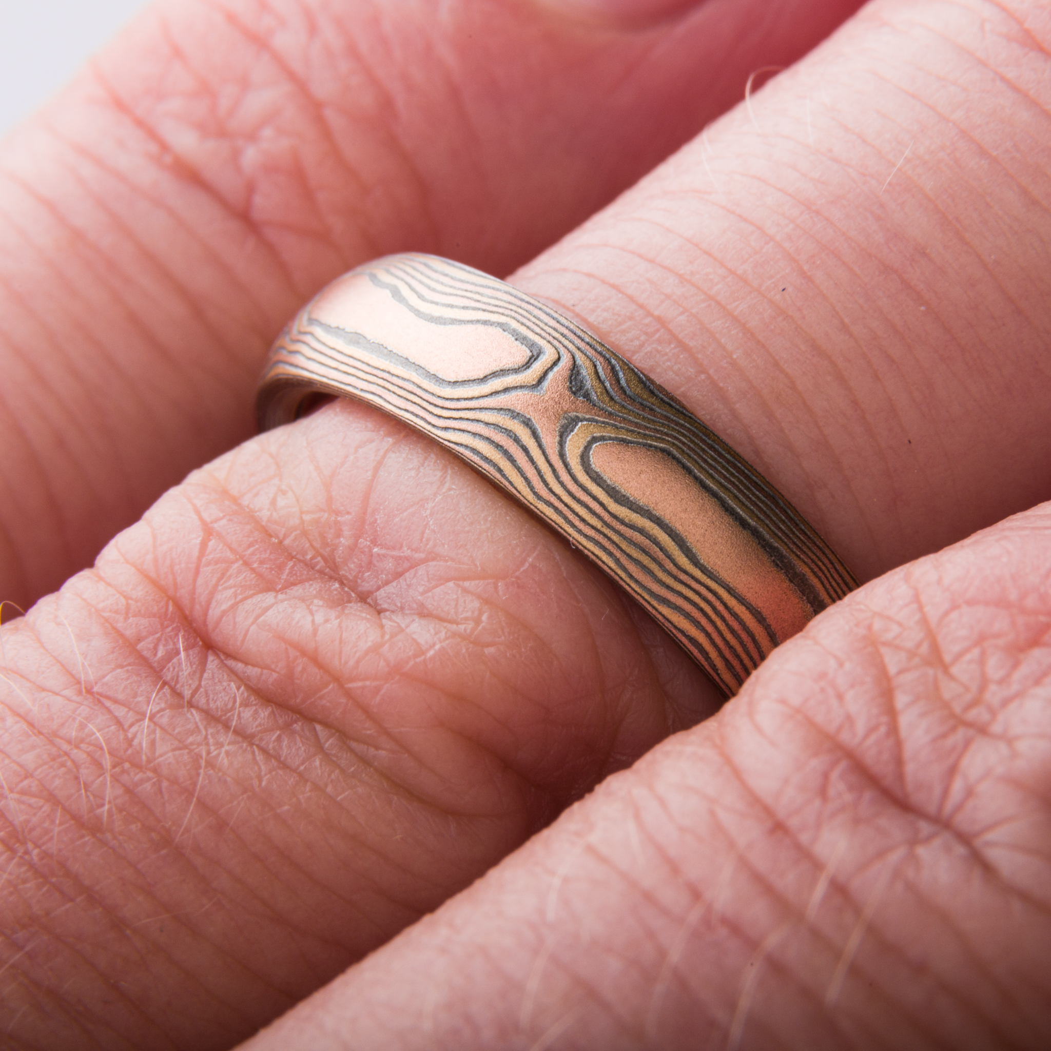 Mokume Gane ring or wedding band custom made arn krebs, fire palette and woodgrain pattern, red gold yellow gold and silver