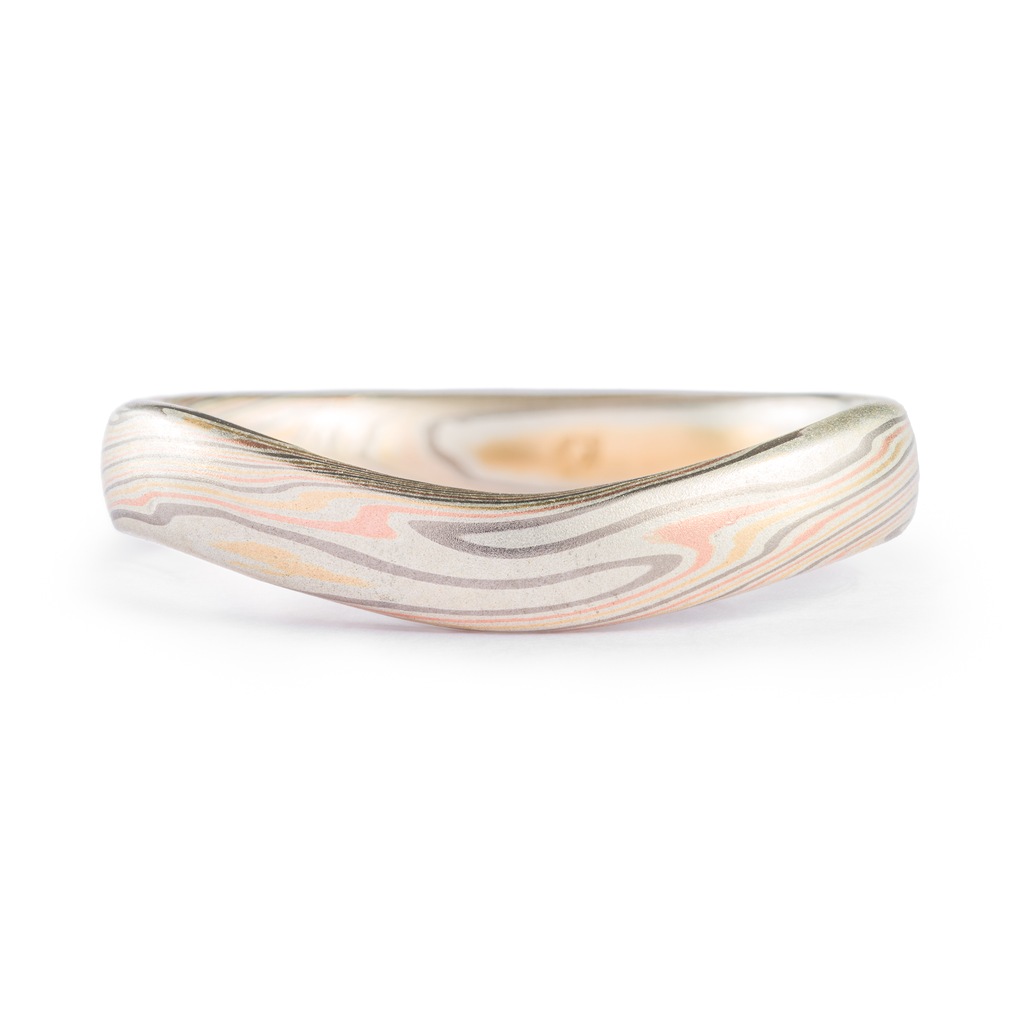 Gently curved mokume gane patterned band made to fit perfectly around an engagement ring. Made with red gold, yellow gold, palladium and silver.