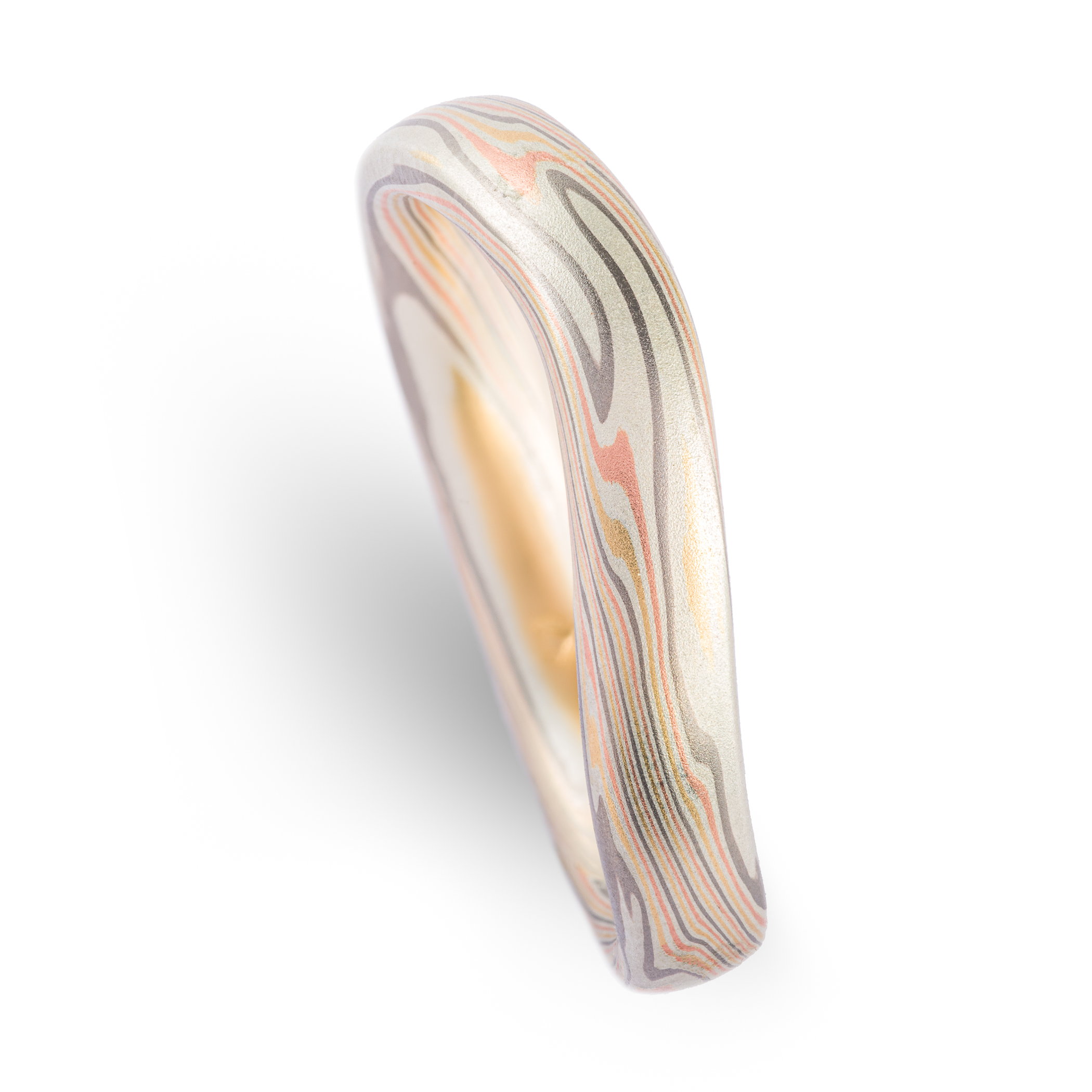 Gently curved mokume gane patterned band made to fit perfectly around an engagement ring. Made with red gold, yellow gold, palladium and silver.