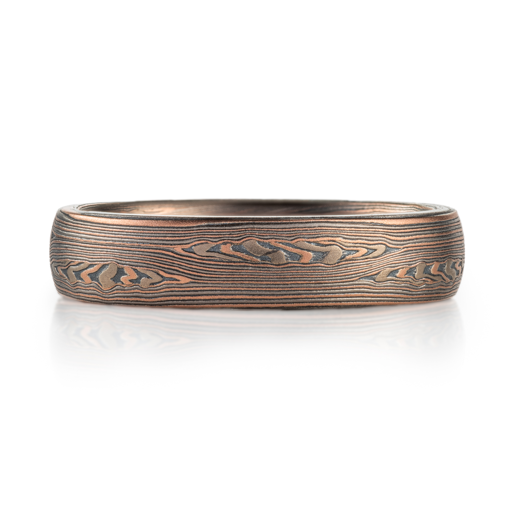 mokume patterned ring made with mainly linear pattern running parallel around the ring, with some areas of increased details, overall darker reddish tone