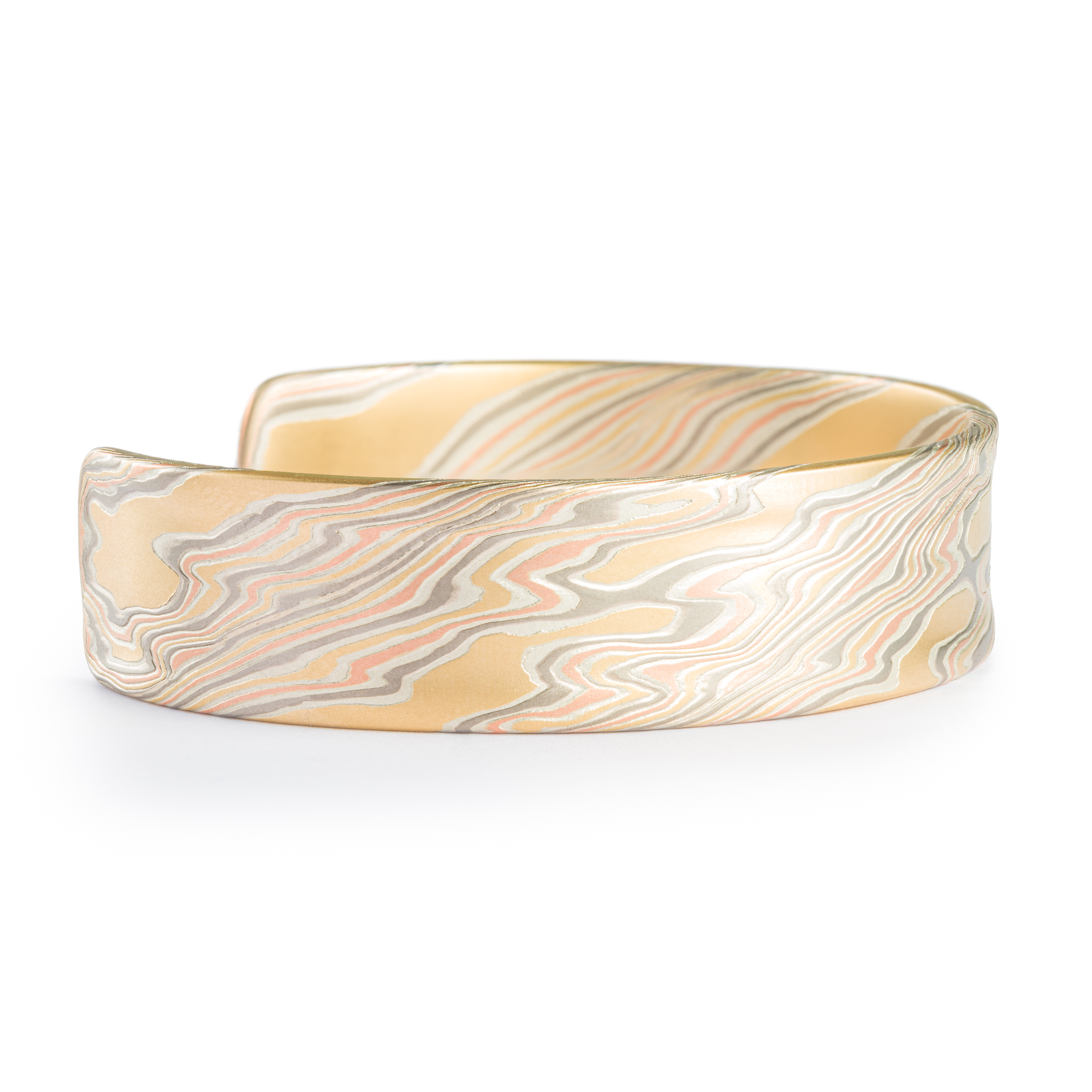 Mokume gane patterned mens bangle, wide, slightly textured, made with yellow gold, red gold, palladium and silver.
