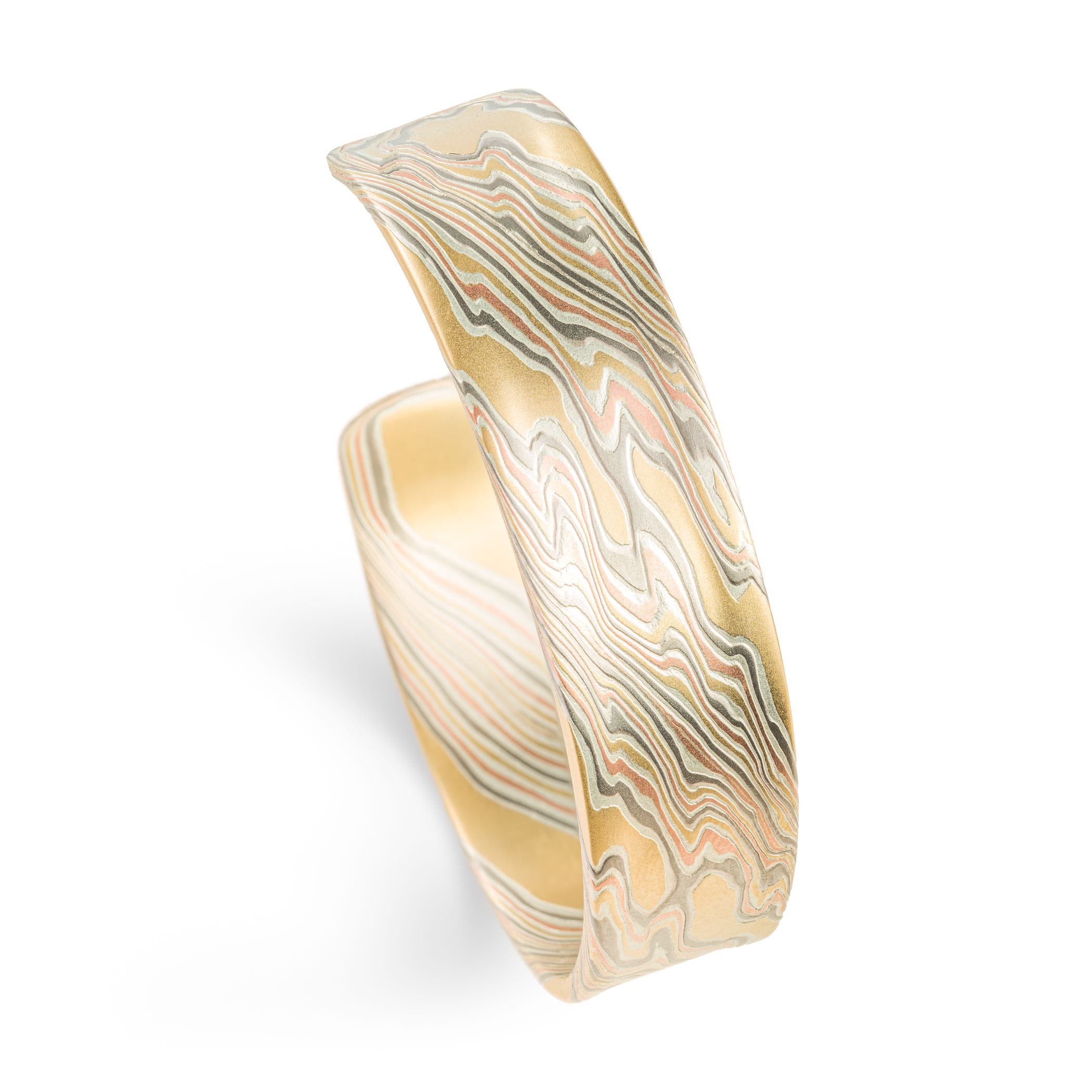 Mokume gane patterned mens bangle, wide, slightly textured, made with yellow gold, red gold, palladium and silver.