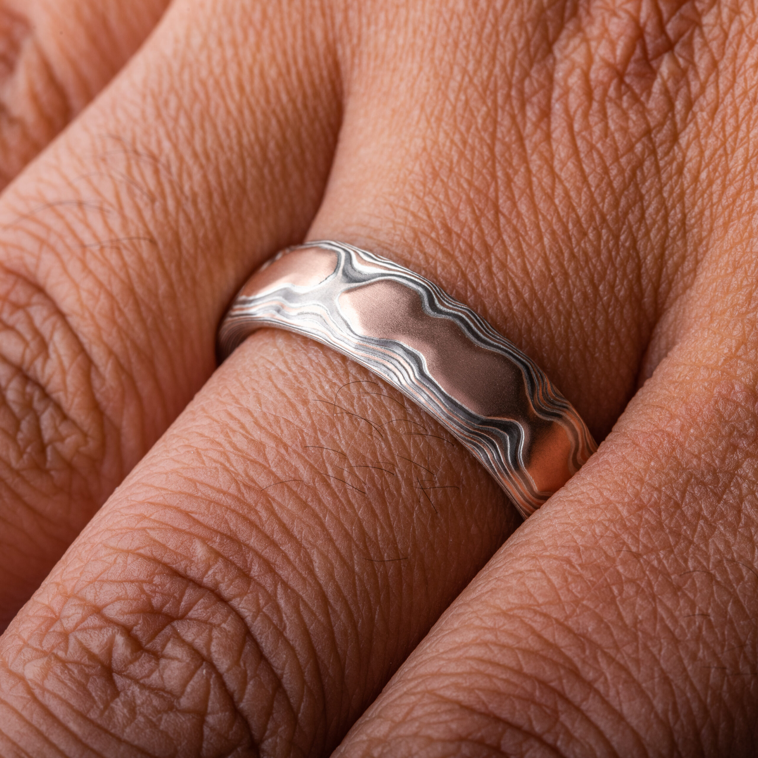 guri bori pattern ring, which is made to resemble a mountain range viewed from above, with red gold and silvery colors