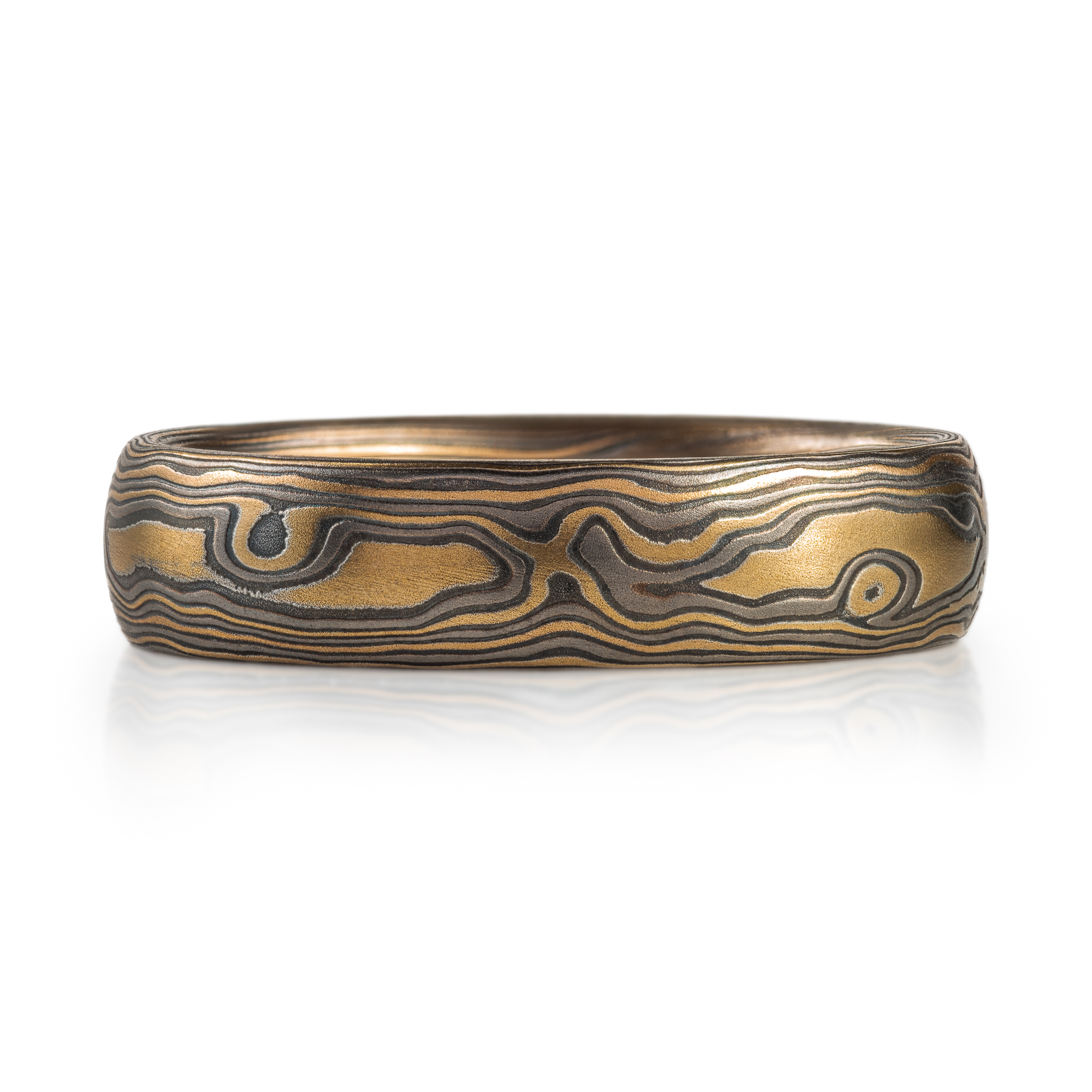 mokume gane woodgrain patterned ring made with yellow gold, palladium (dark gray) and oxidized silver (black)