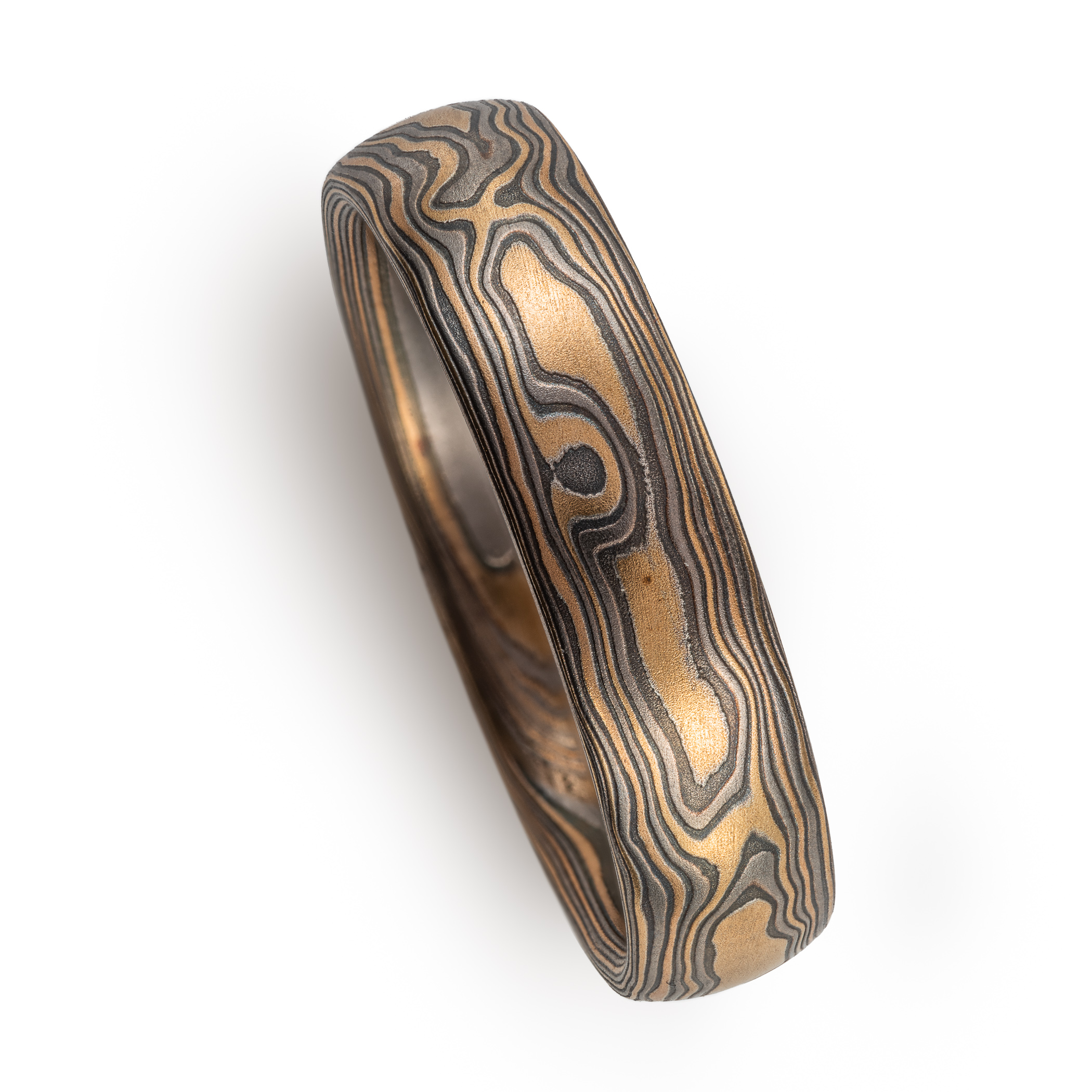 mokume gane woodgrain patterned ring made with yellow gold, palladium (dark gray) and oxidized silver (black)
