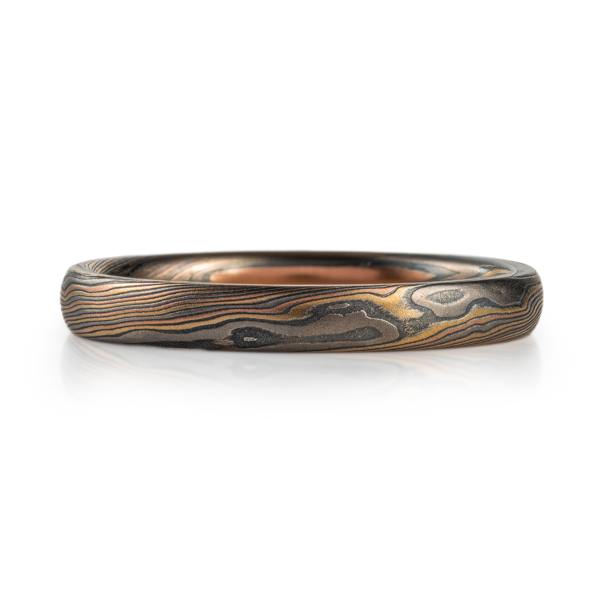 Narrow mokume gane patterned ring made with multiple metals, for an overall woodsy, nature inspired ring.
