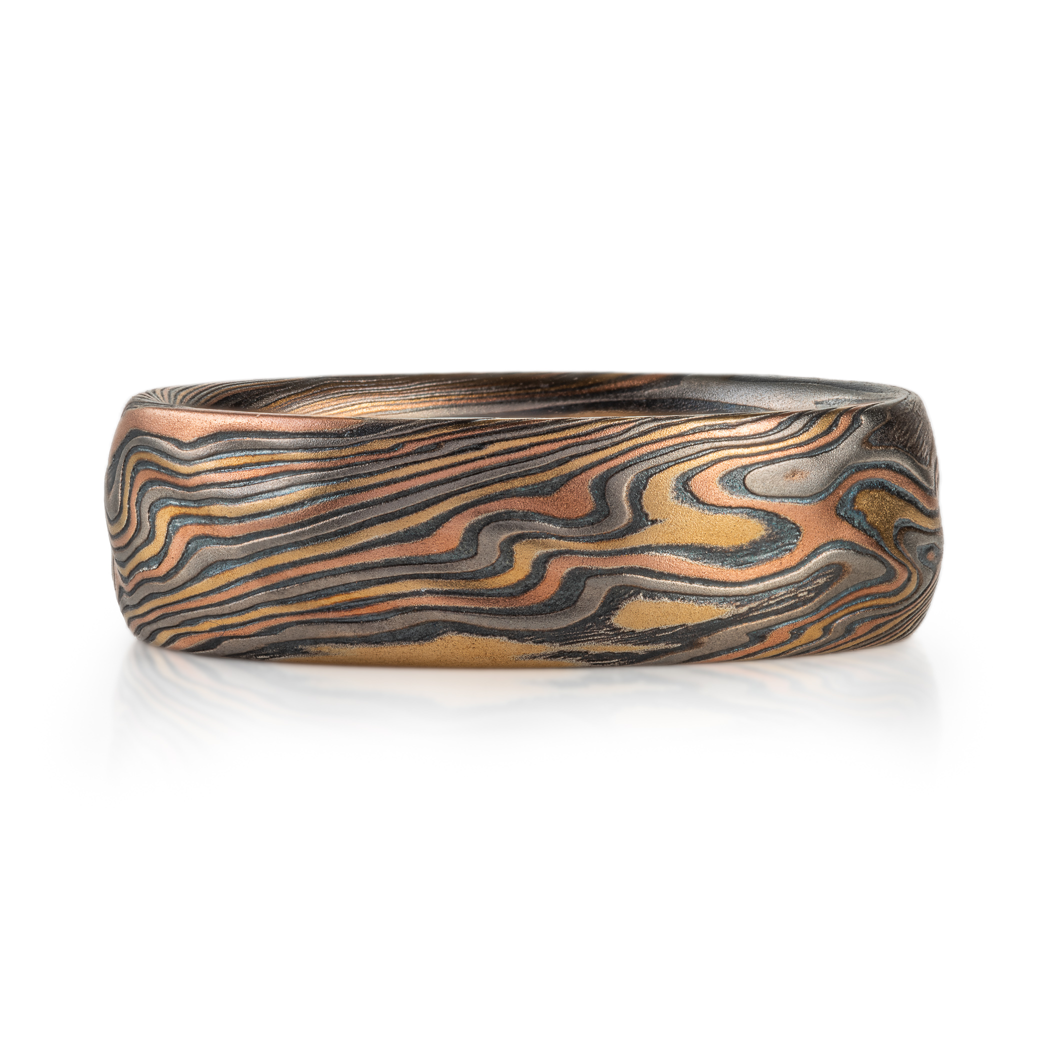 mokume gane wedding band with red gold yellow gold palladium and oxidized silver