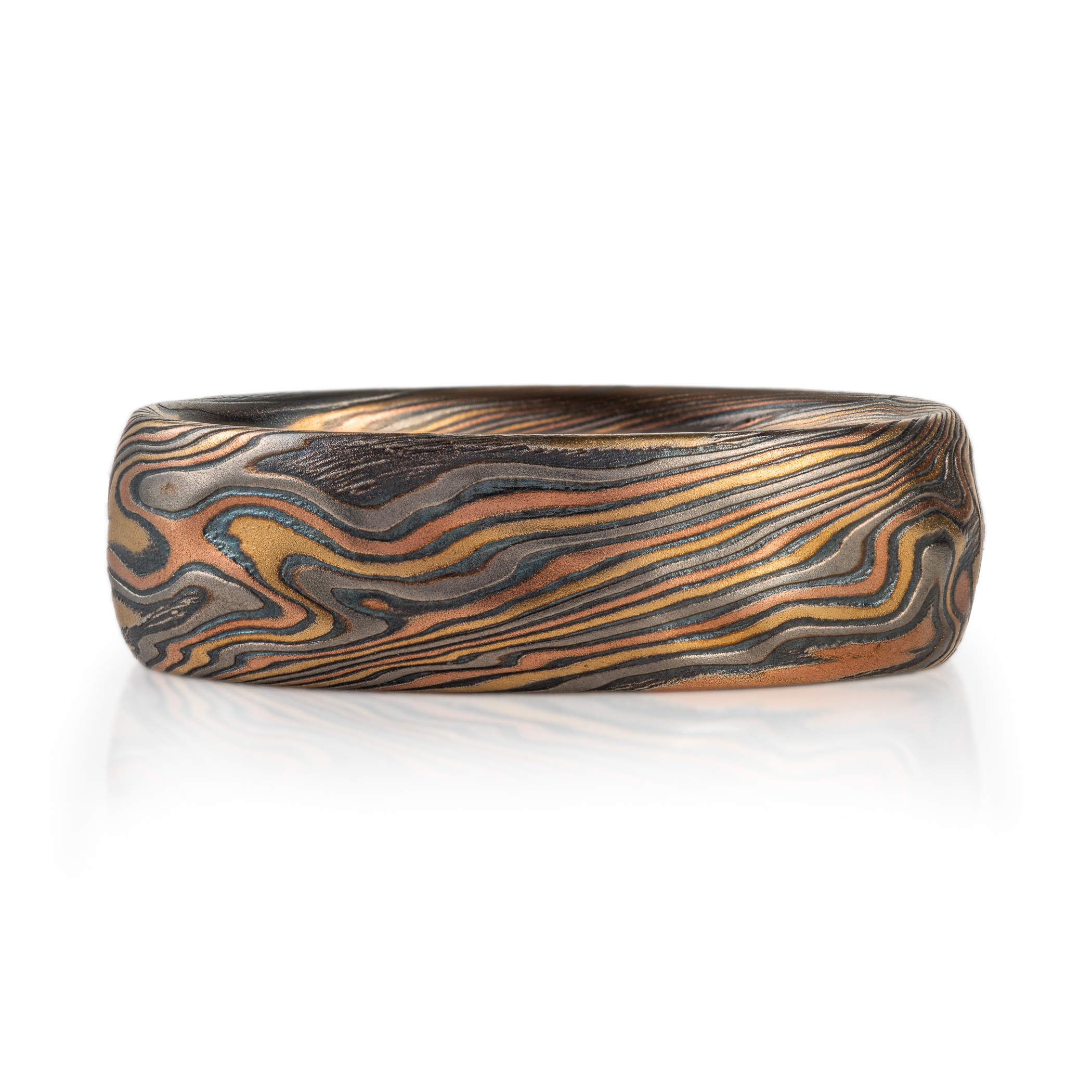 mokume gane wedding band with red gold yellow gold palladium and oxidized silver