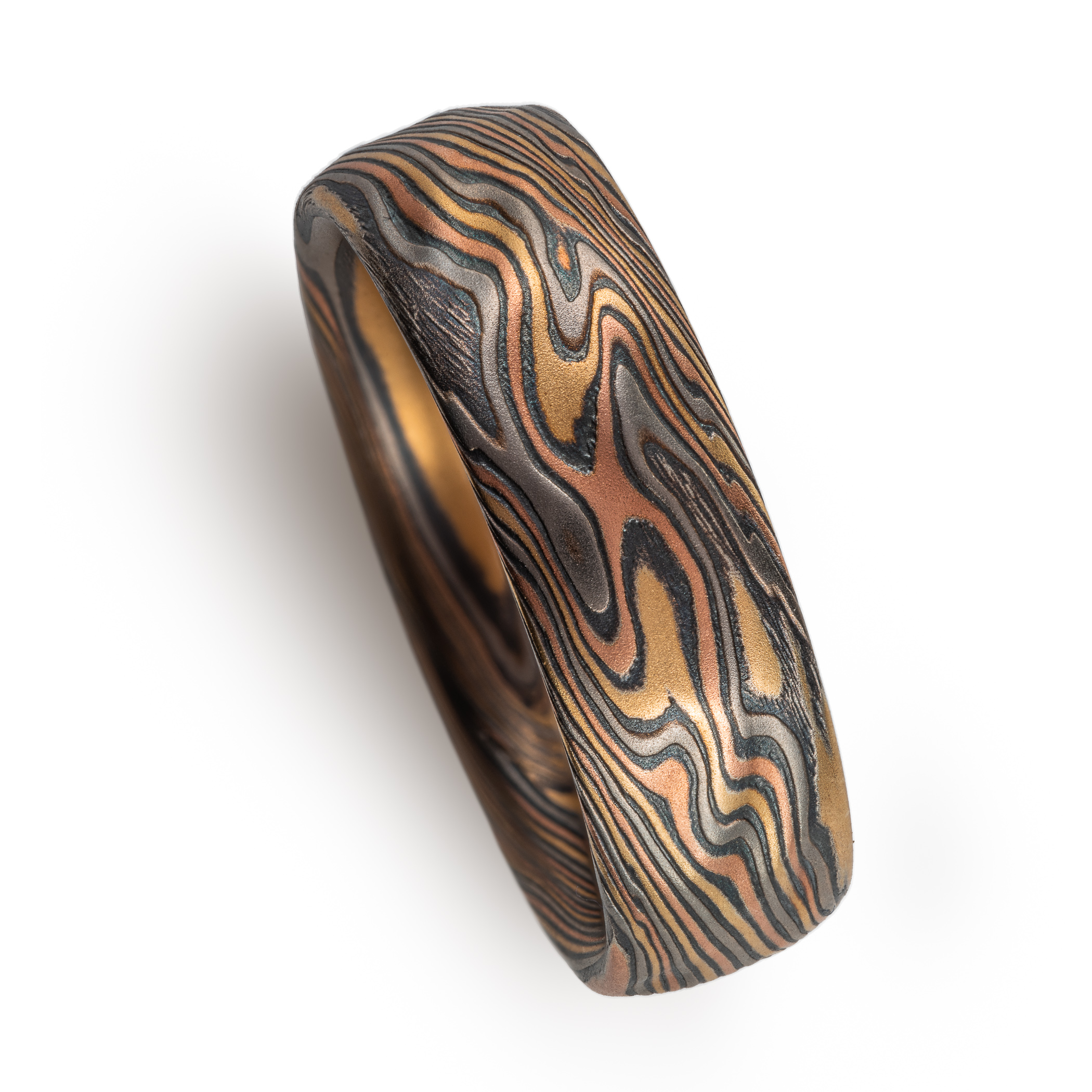 mokume gane wedding band with red gold yellow gold palladium and oxidized silver