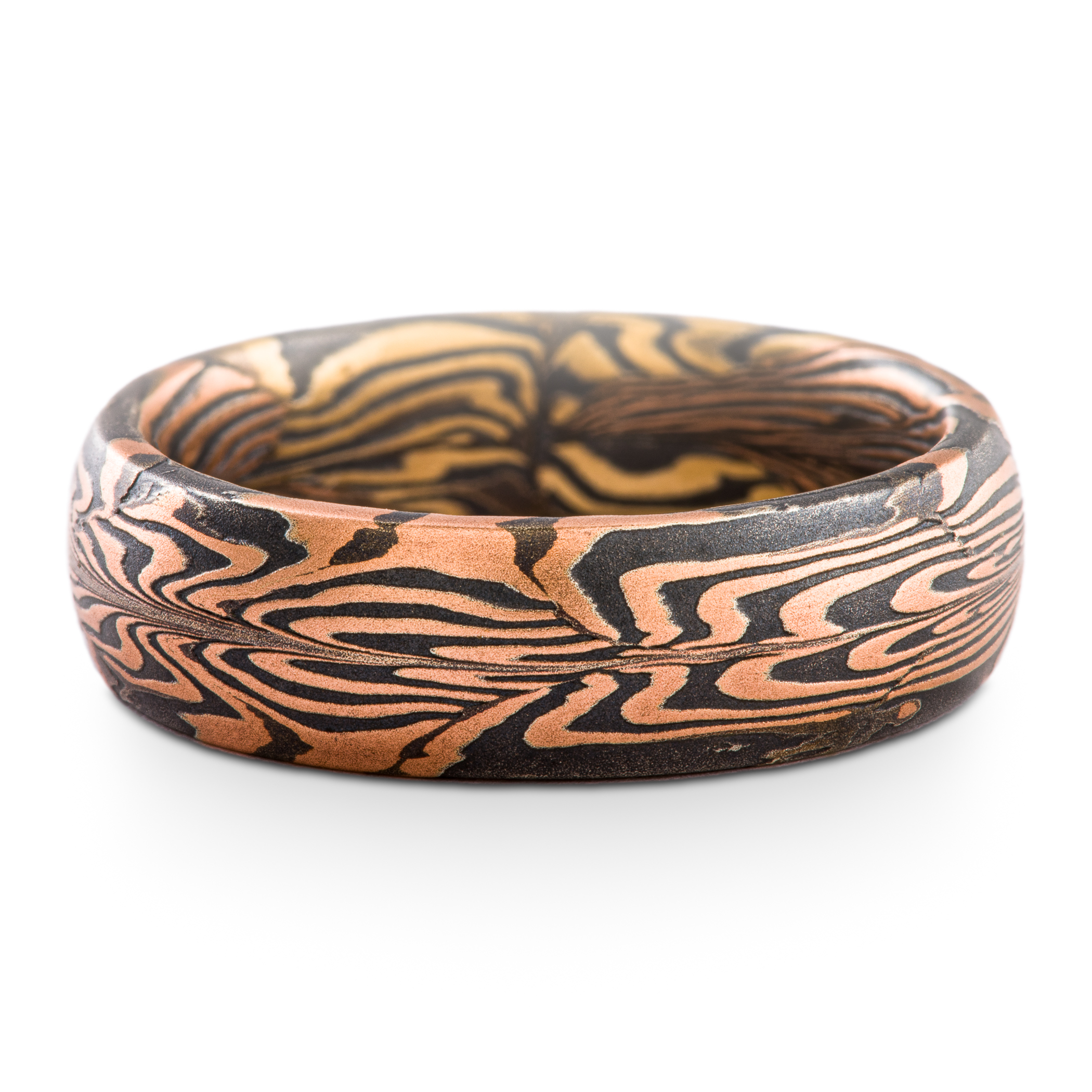 Uniquely patterned mokume gane ring in half red gold, half yellow gold, with oxidized silver.