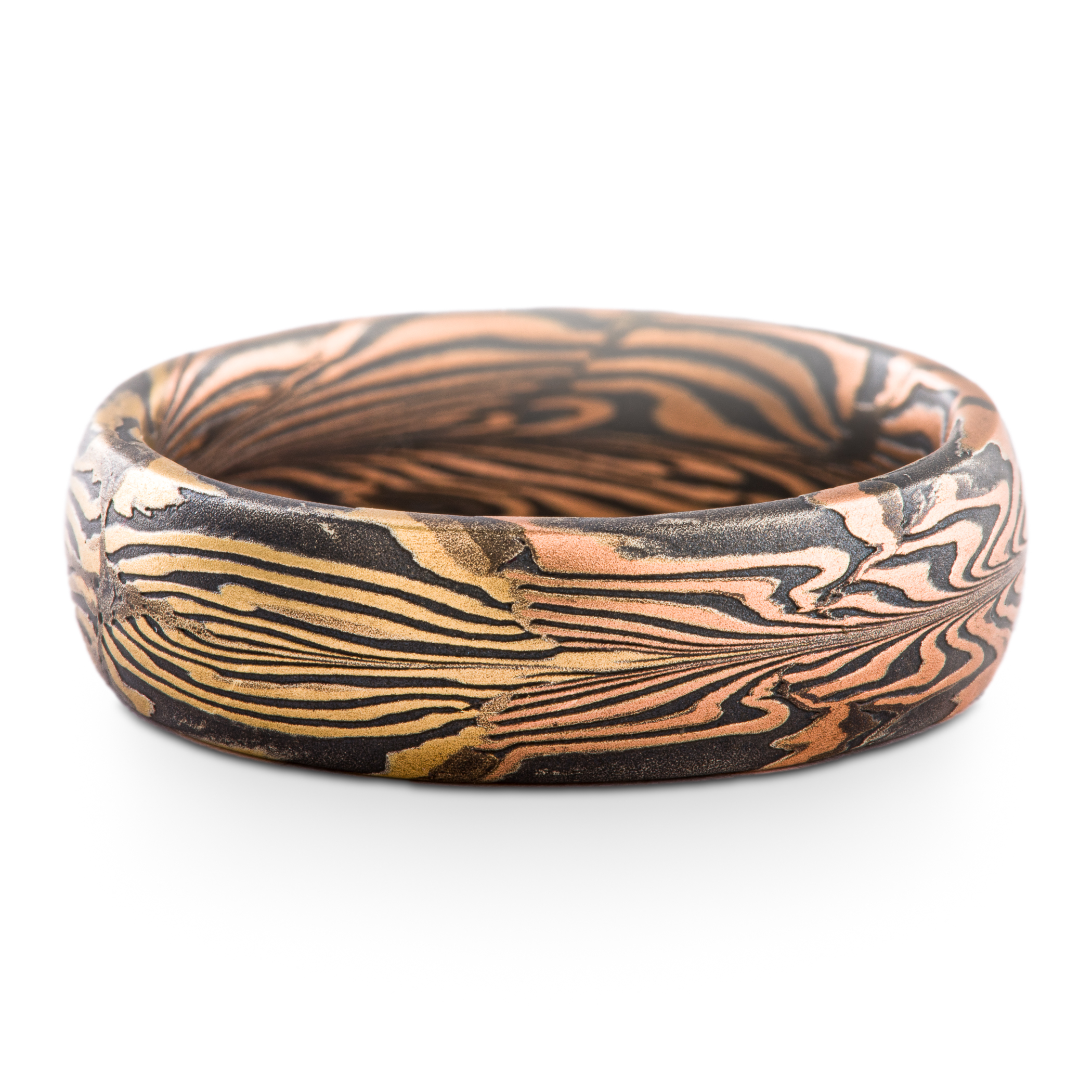 Uniquely patterned mokume gane ring in half red gold, half yellow gold, with oxidized silver.