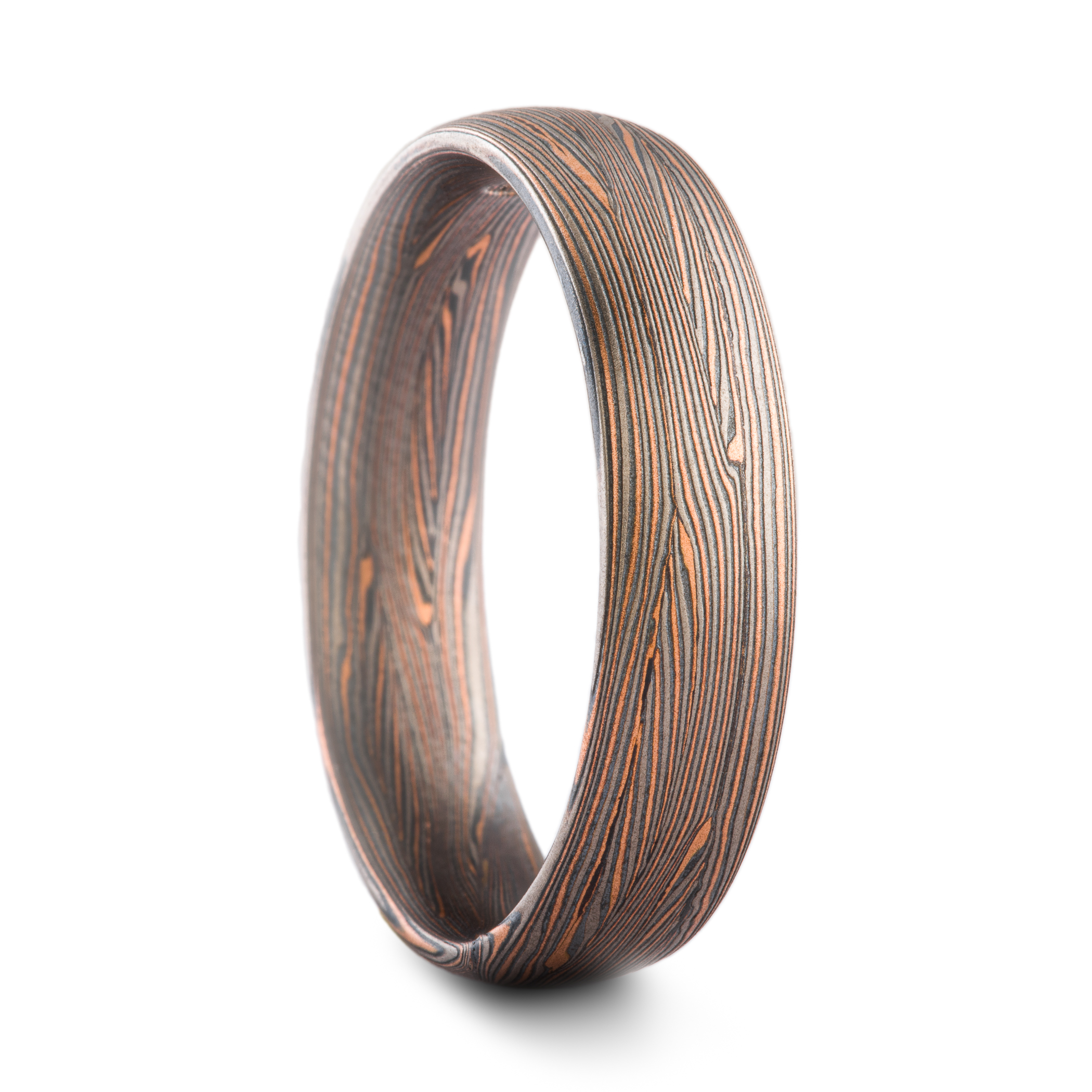 Mokume gane ring made in Arn Krebs Flow pattern made in a linear style with flowing fine lines. Made with red gold, palladium and oxidized silver.