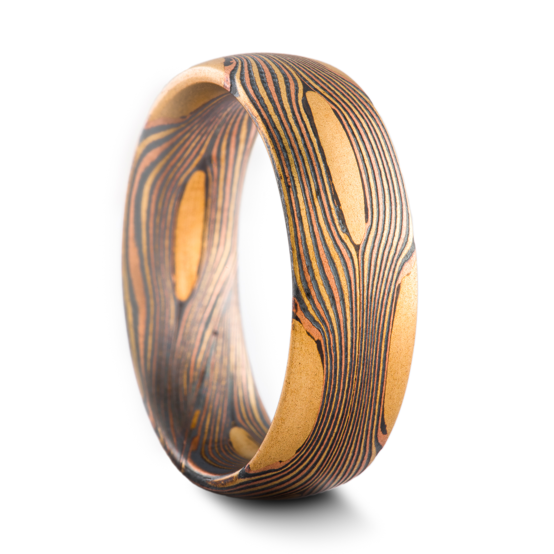 Arn Krebs Mokume Gane patterned ring, made with thin flowing lines of gold with yellow gold patches interspersed.