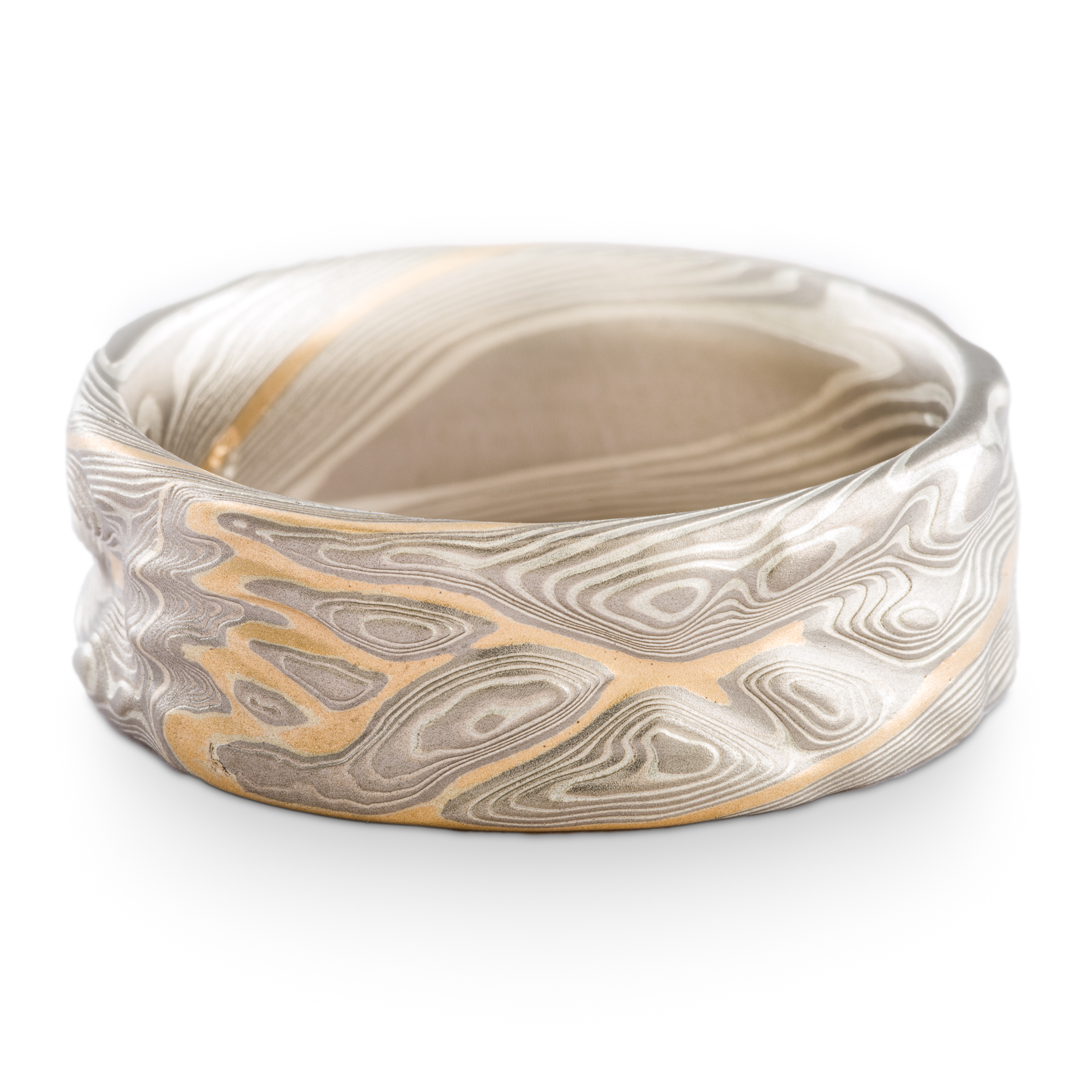 Textured mokume gane ring made with palladium and silver with a river of yellow gold weaving through it.