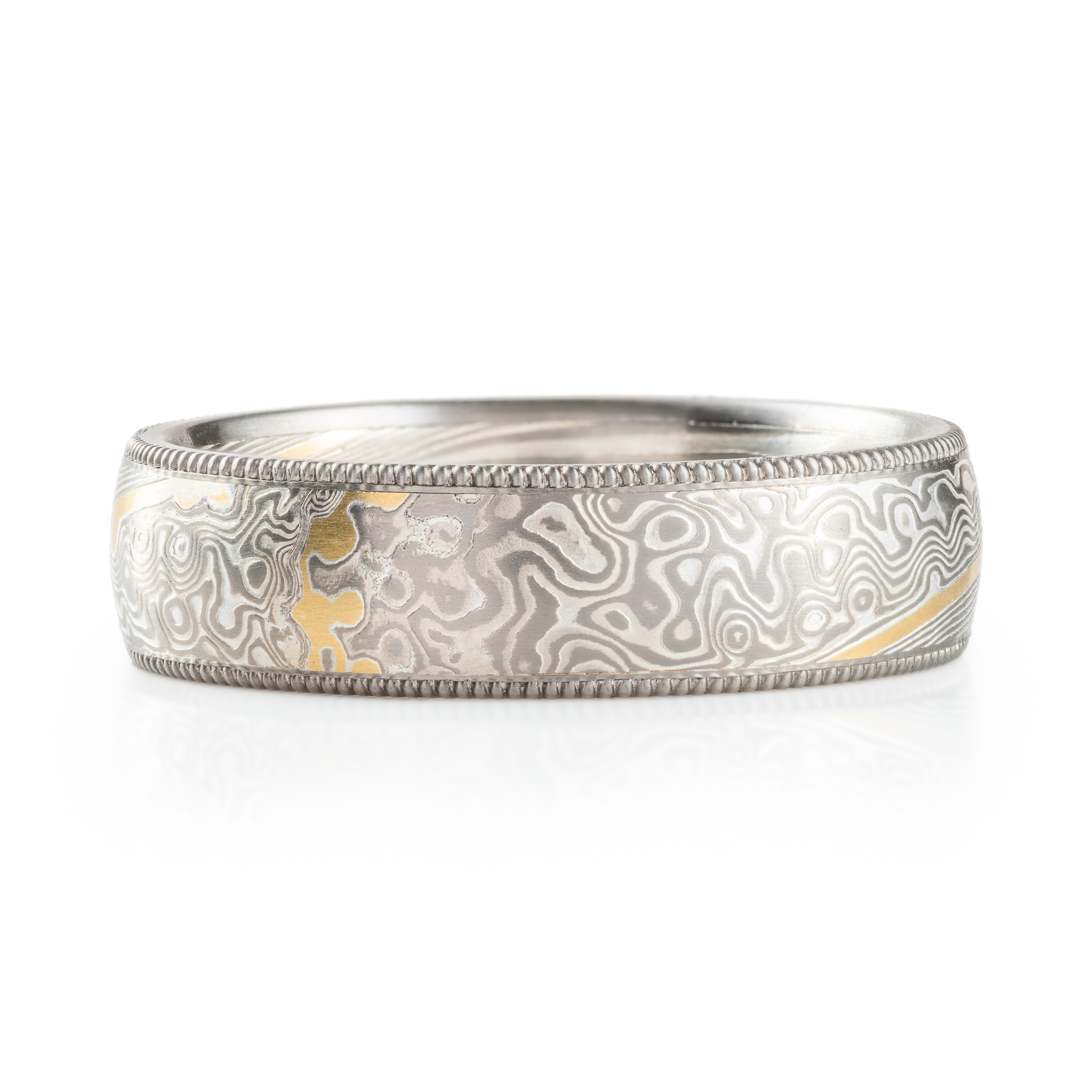 elegant wedding style band with bead set salt and pepper diamonds and milgrain rails on top and bottom edges and an added yellow gold stratum