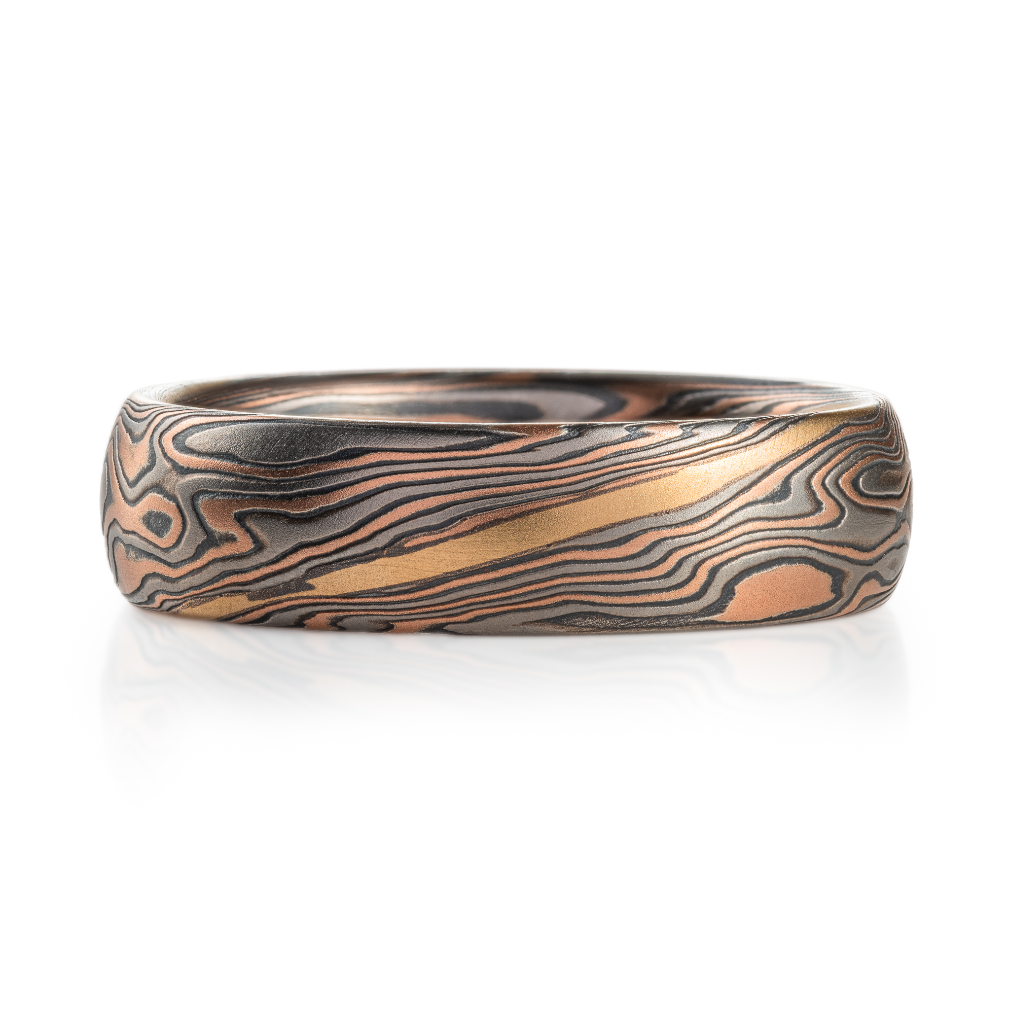 hand carved and handmade twisted metal and stripes of gold. yellow gold , red gold, silver and palladium swirled metal. wide, carved ring for a man