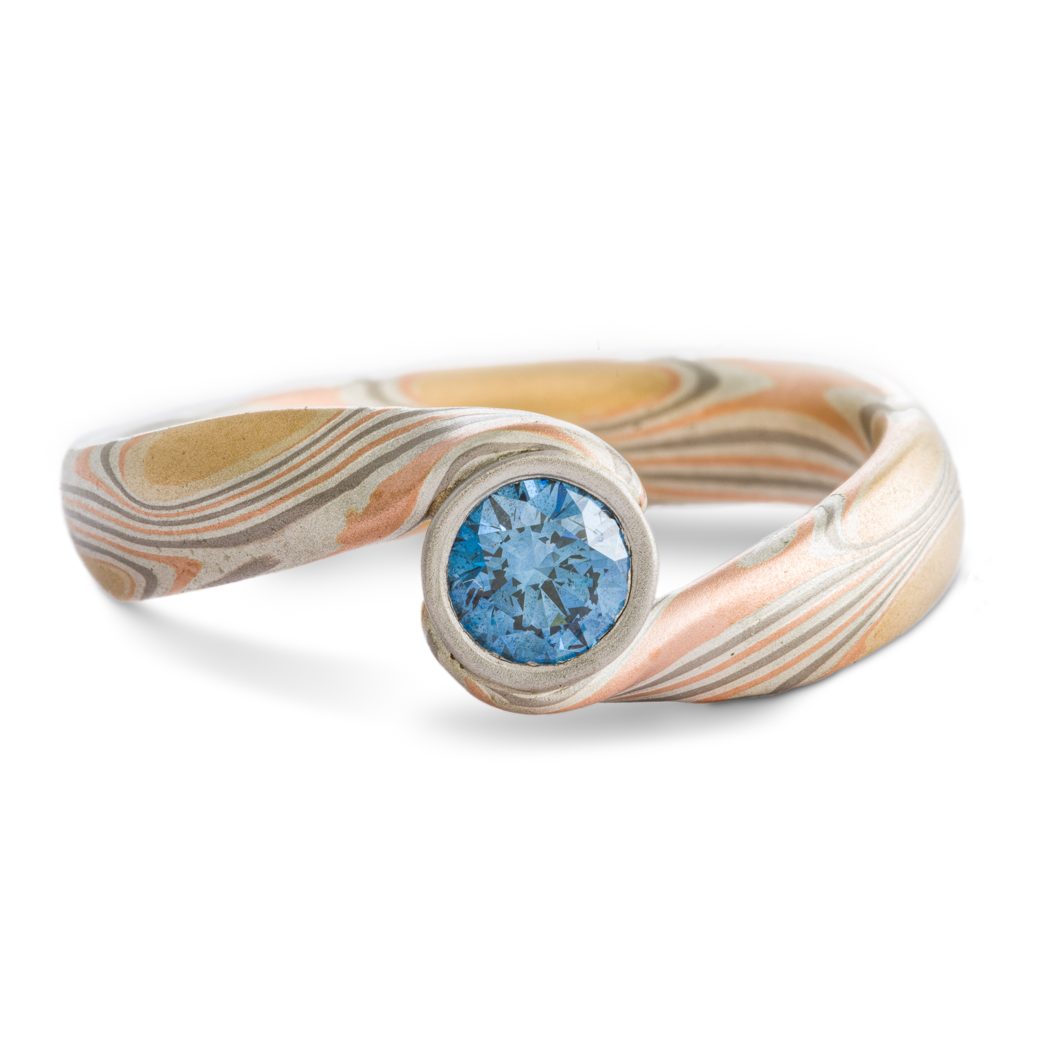Blue Diamond mokume gane ring made with golds, palladium and silver in a swirling pattern, with a gently sloping and twisted band.
