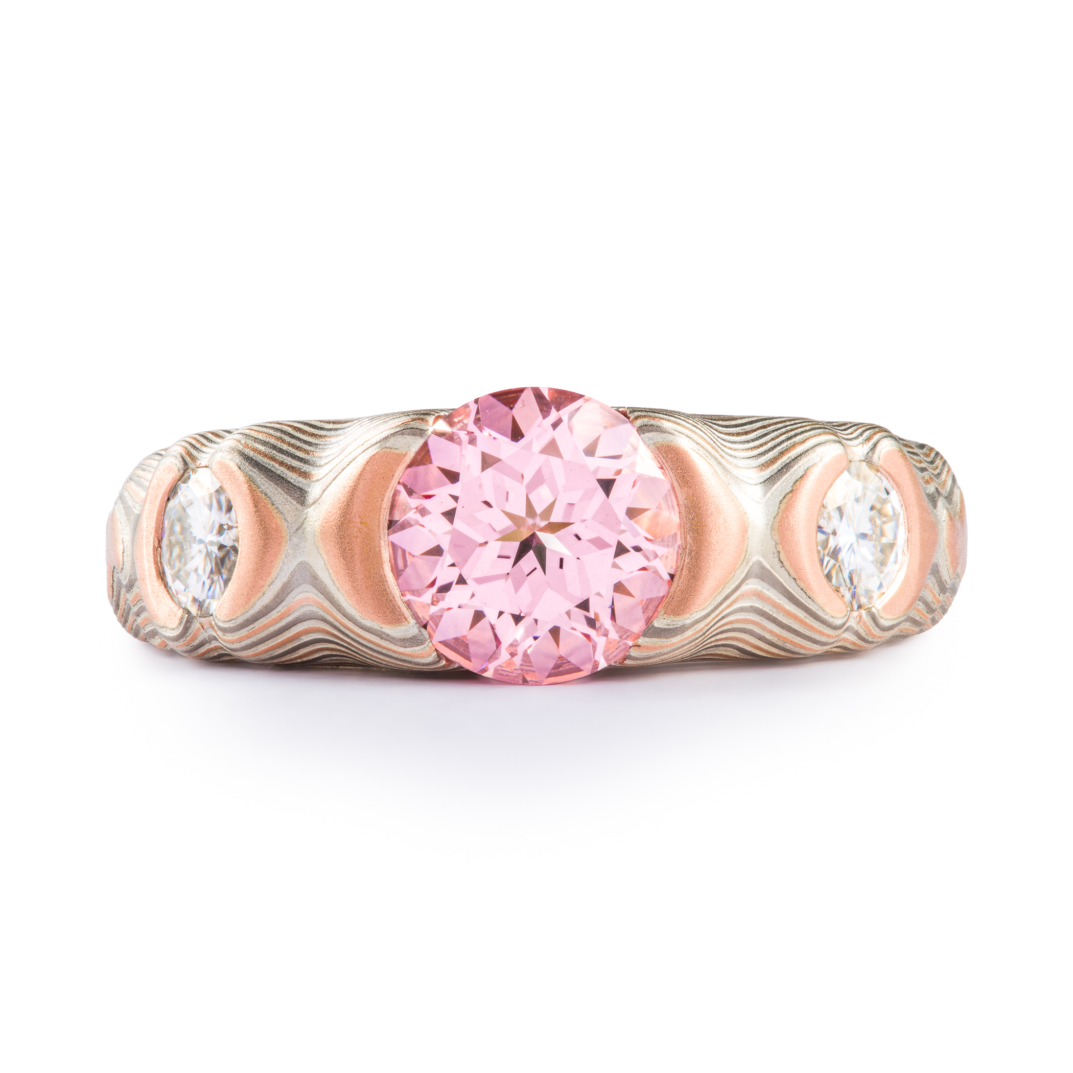Tapered red gold, palladium and silver mokume gane patterned ring, cathedral style setting with a large pink stone, flanked on each side by a smaller white stone.