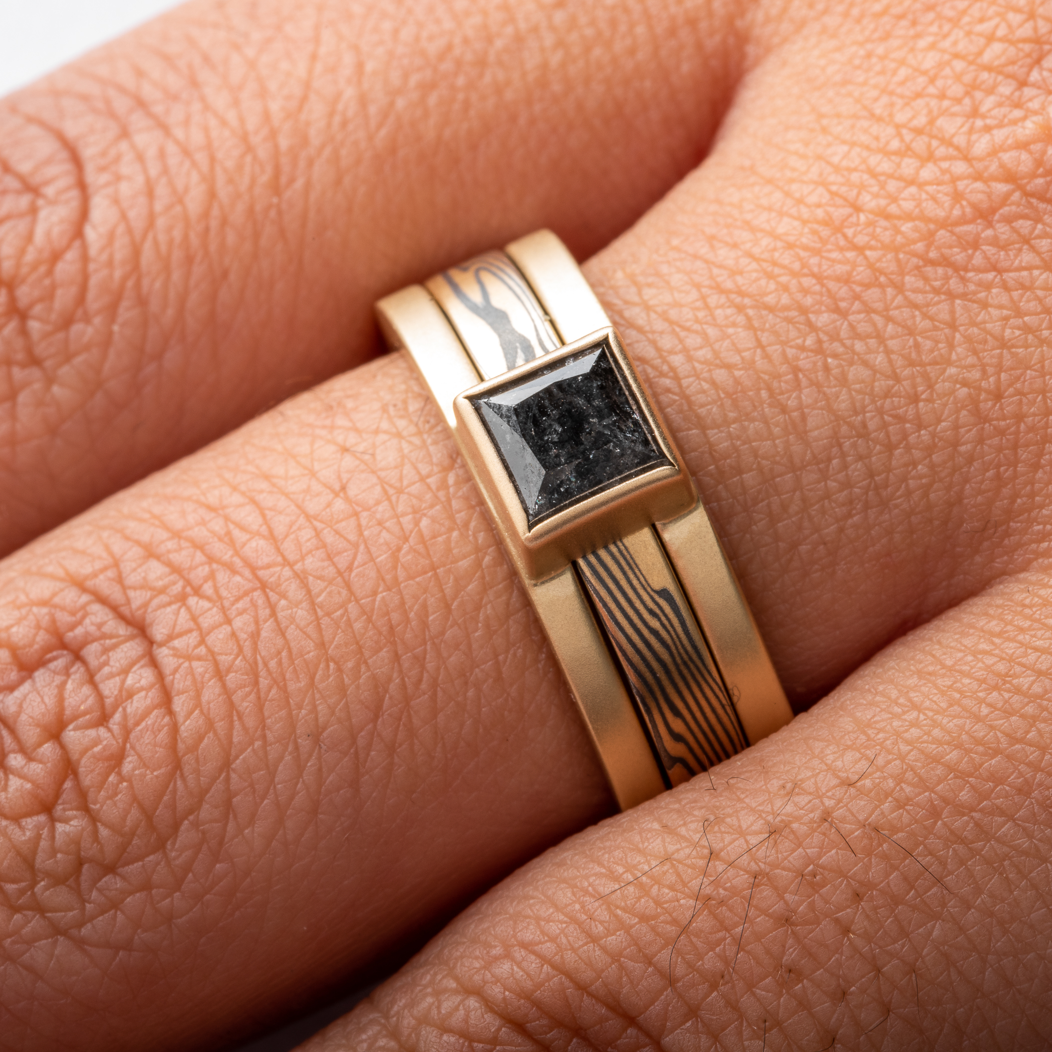 Mokume Gane gold and silver ring with gold ring guard with square black diamond.
