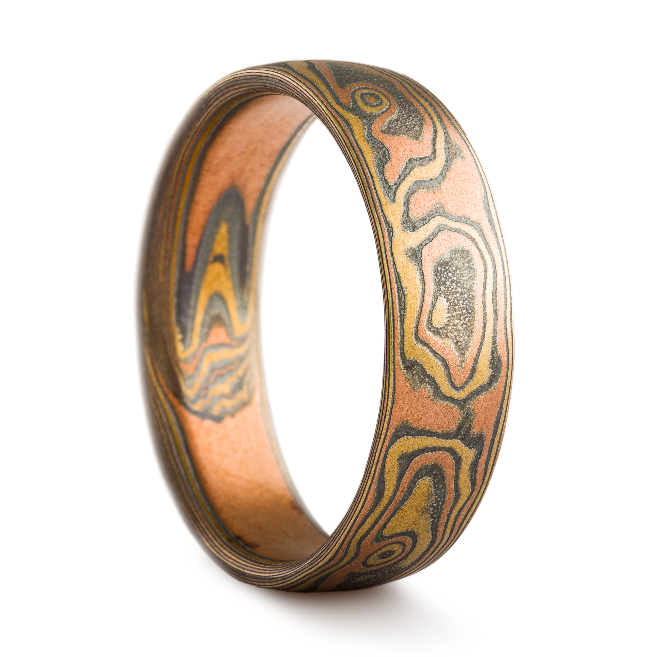 Ring made in mokume gane pattern, with red gold, yellow gold and oxidized silver.
