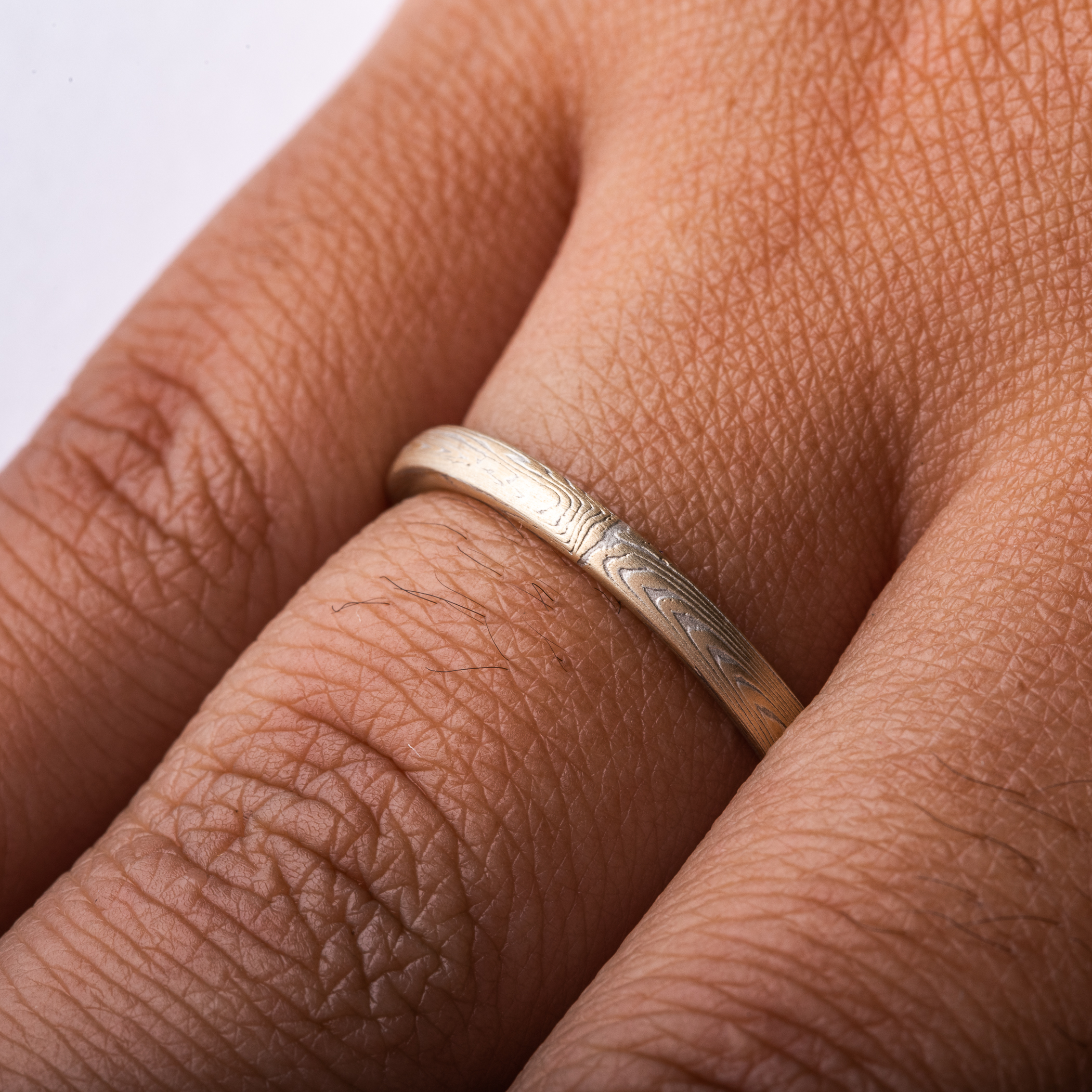 Arn Krebs mokume gane ring patterned in a subtle linear style in his vortex pattern. Made with yellow gold and silver.