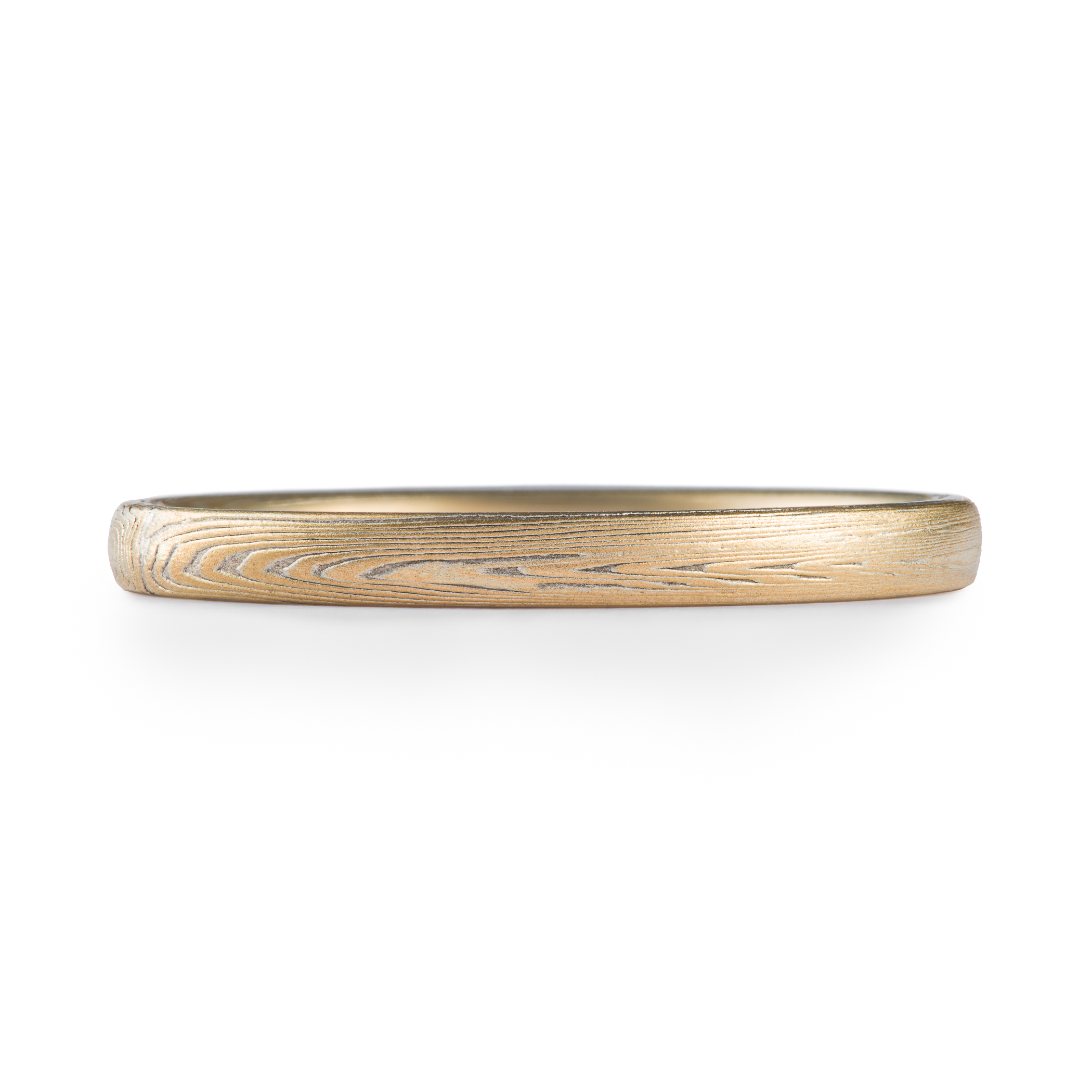Arn Krebs mokume gane ring patterned in a subtle linear style in his vortex pattern. Made with yellow gold and silver.