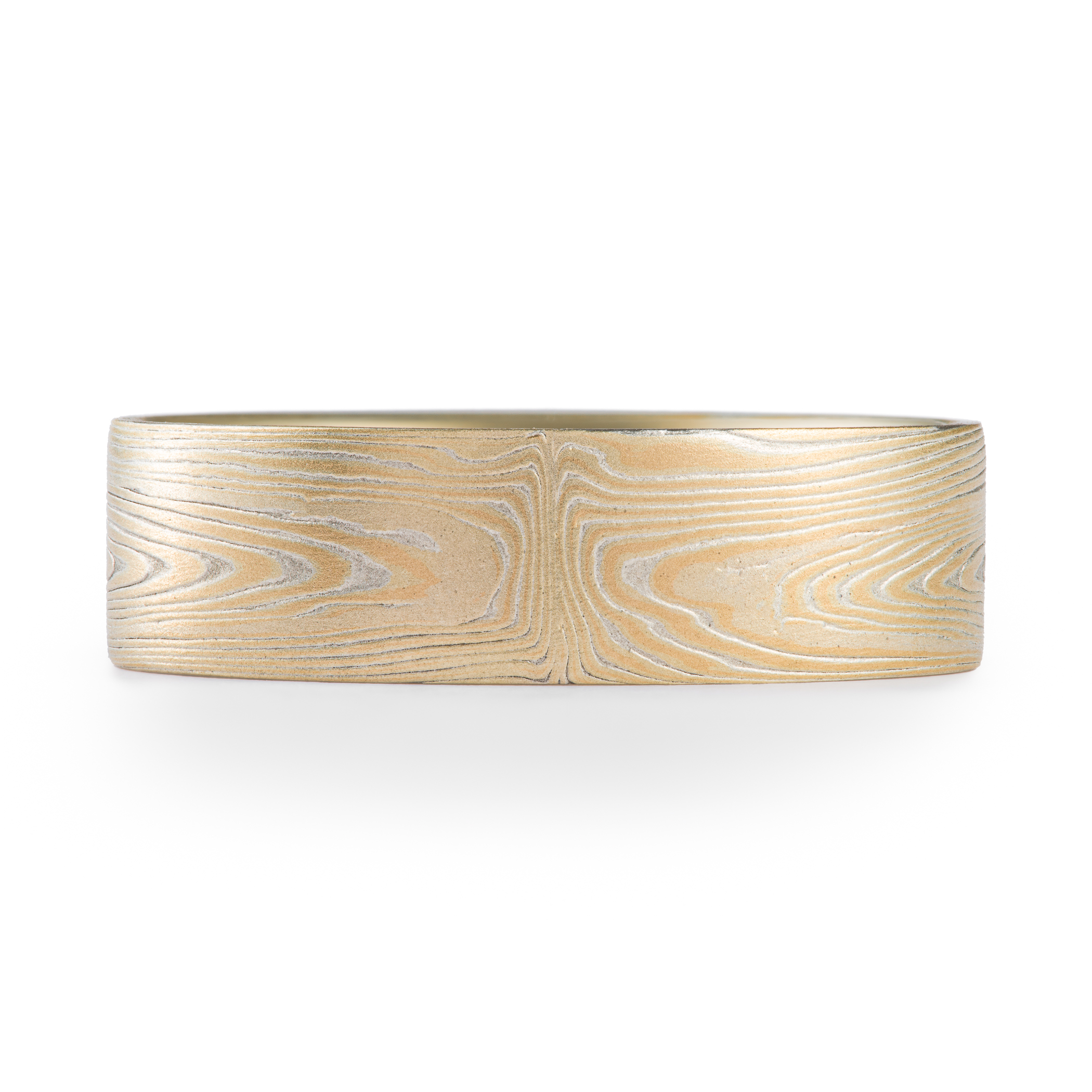 Arn Krebs mokume gane ring patterned in a subtle linear style in his vortex pattern. Made with yellow gold and silver.