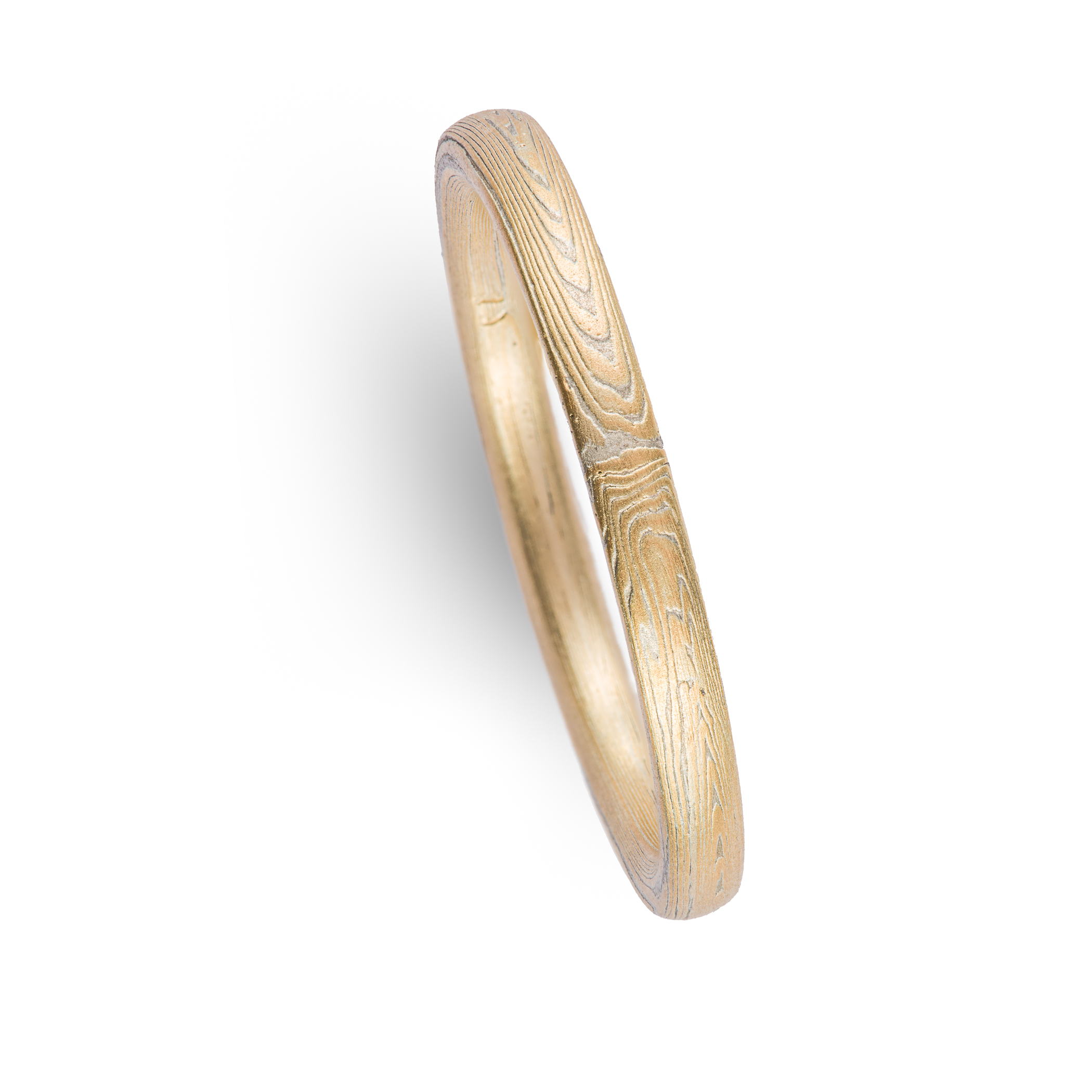 Arn Krebs mokume gane ring patterned in a subtle linear style in his vortex pattern. Made with yellow gold and silver.